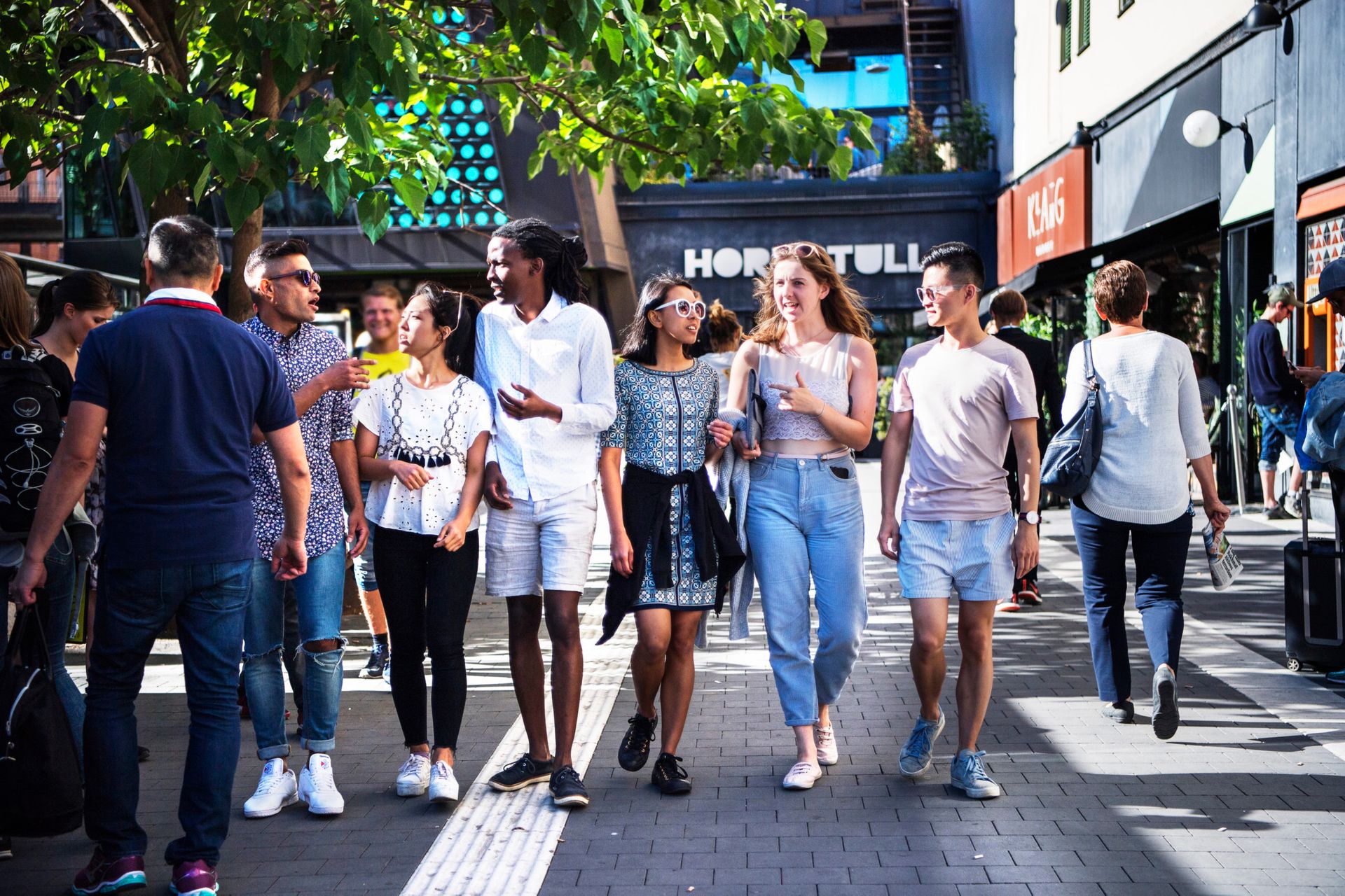 Group of international students walking along a shopping street in Stockholm.