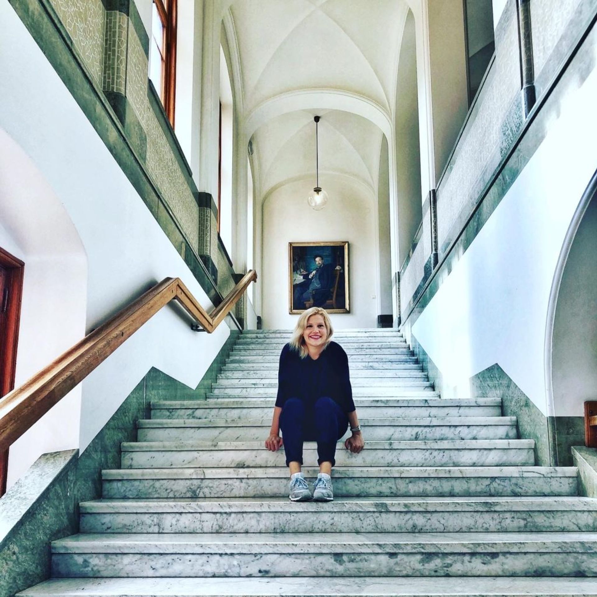 Sara sitting on the steps of an art museum.