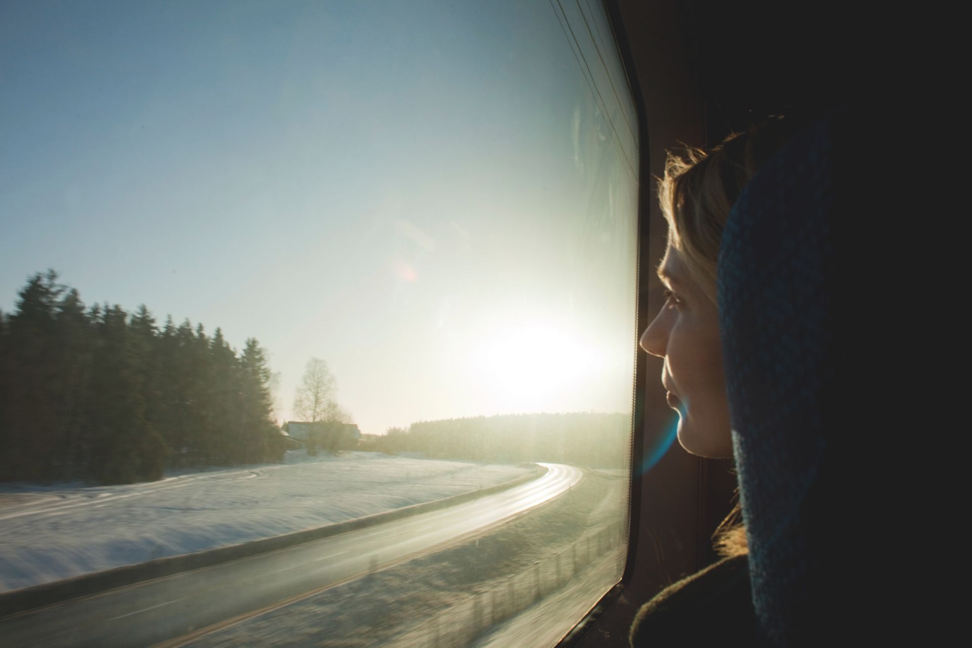 Person looking out the window of a moving train.