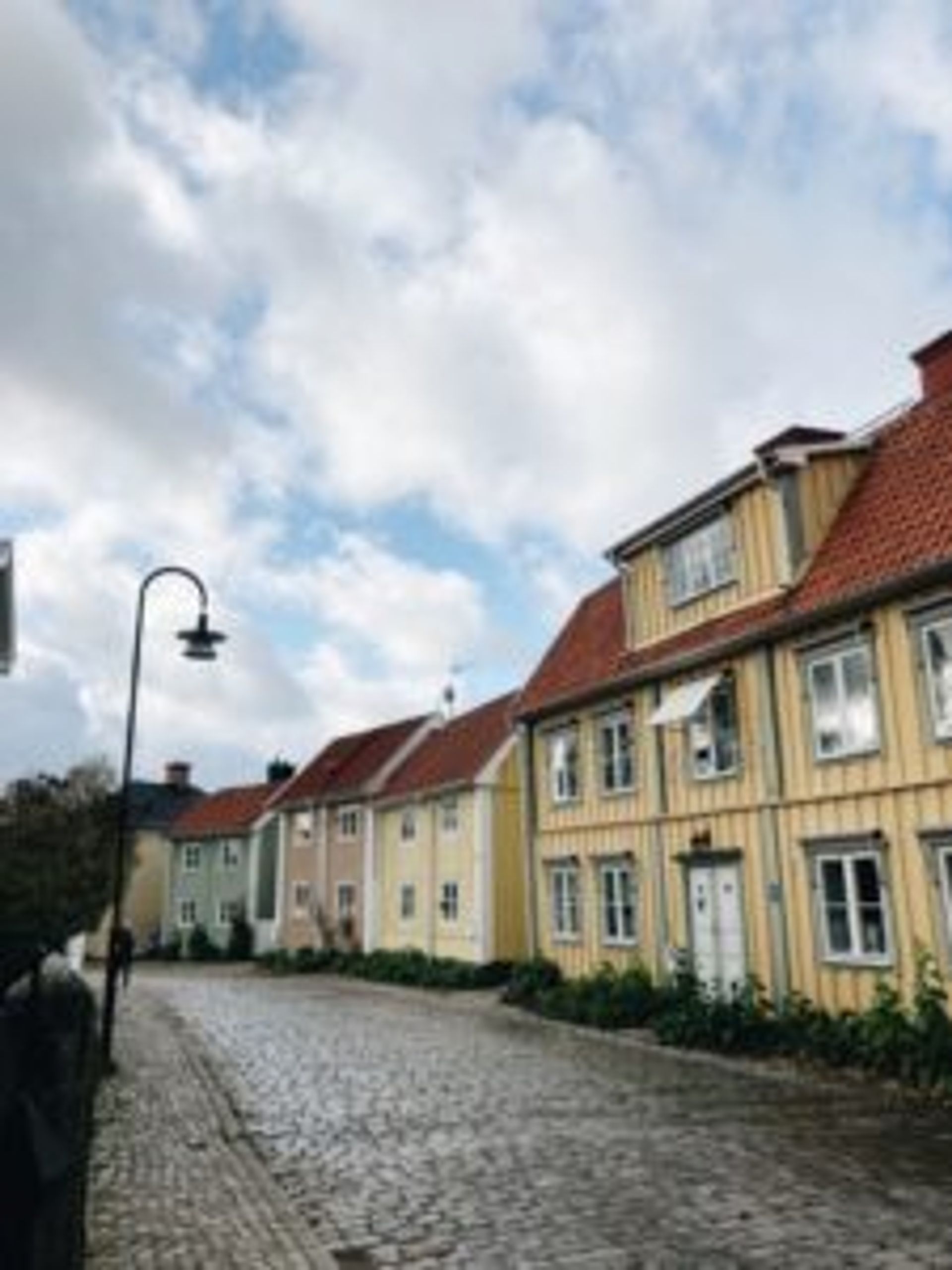 Colourful, wooden buildings in a street.