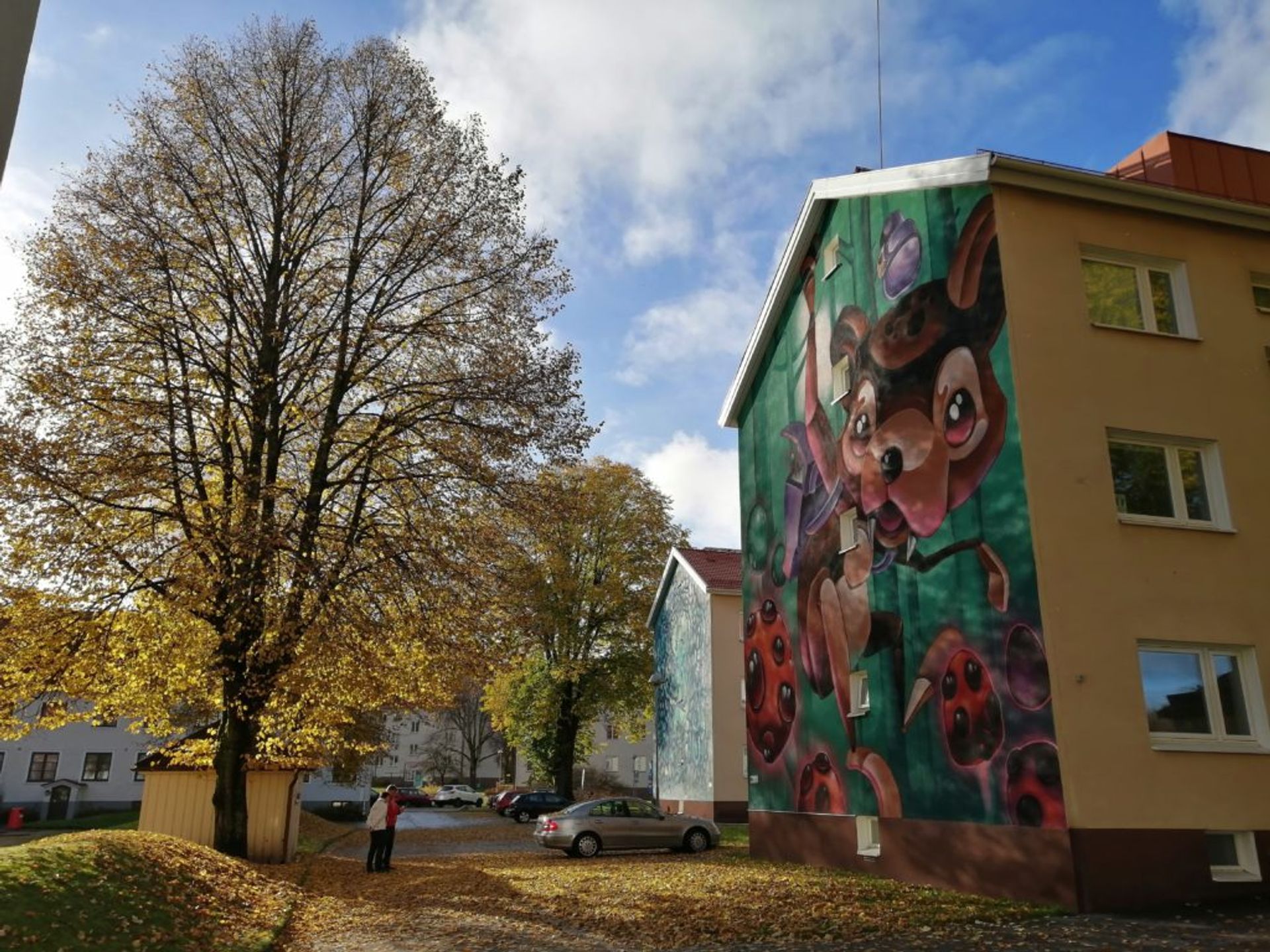 Mural in golden autumn landscape in Norrby suburb.