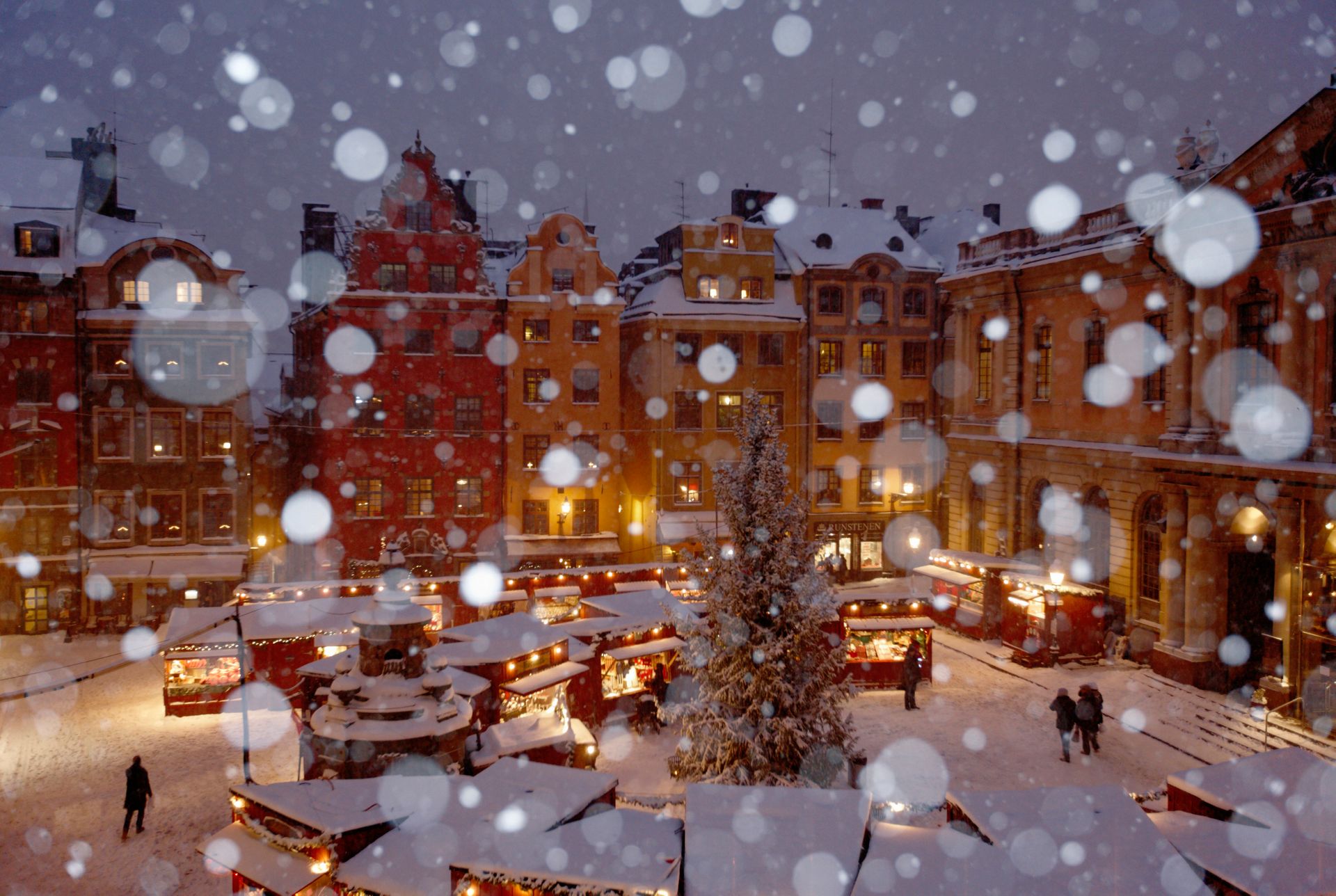 A snowy Christmas market in a square in Stockholm's Old Town.