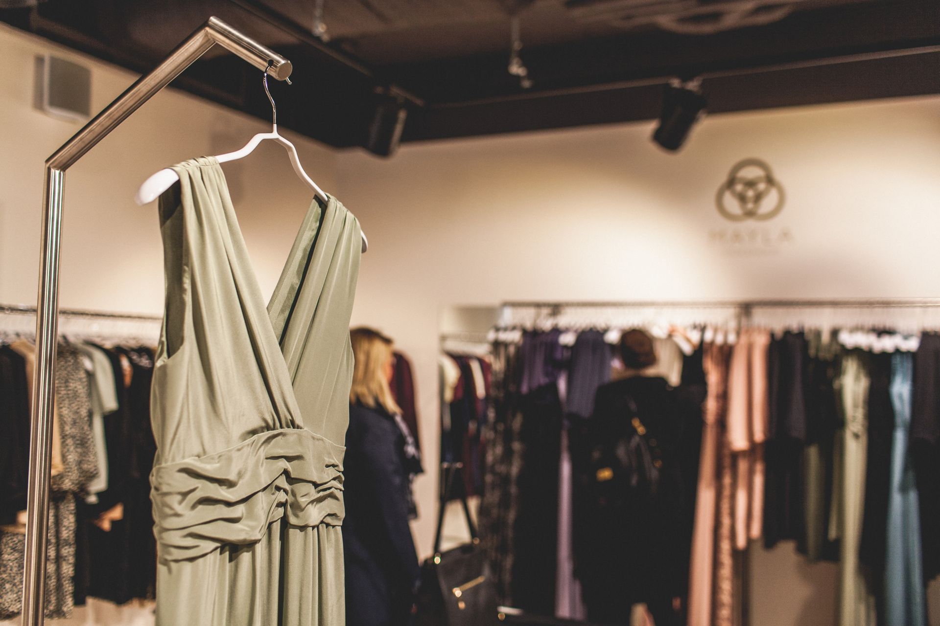 Racks of women's clothing in a designer store.