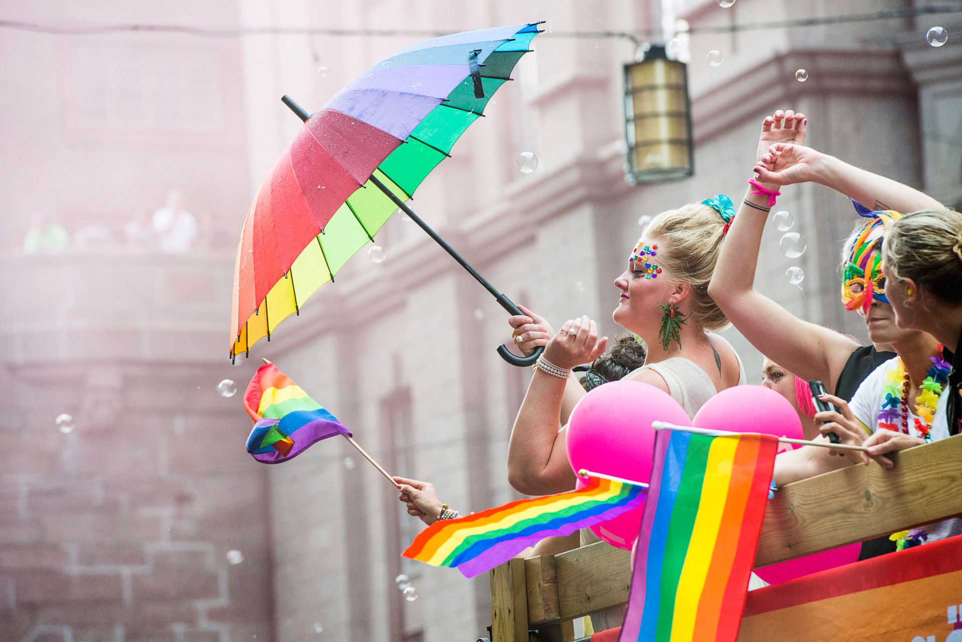 Person touts rainbow umbrella at Pride Festival in Stockholm