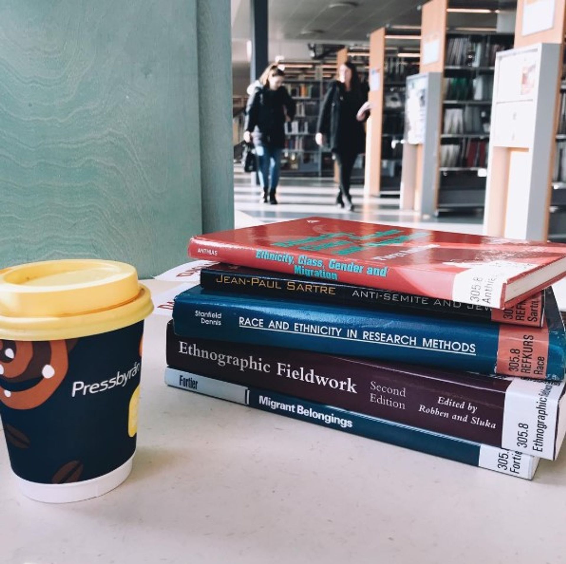 Close-up of university books and a cup of coffee.