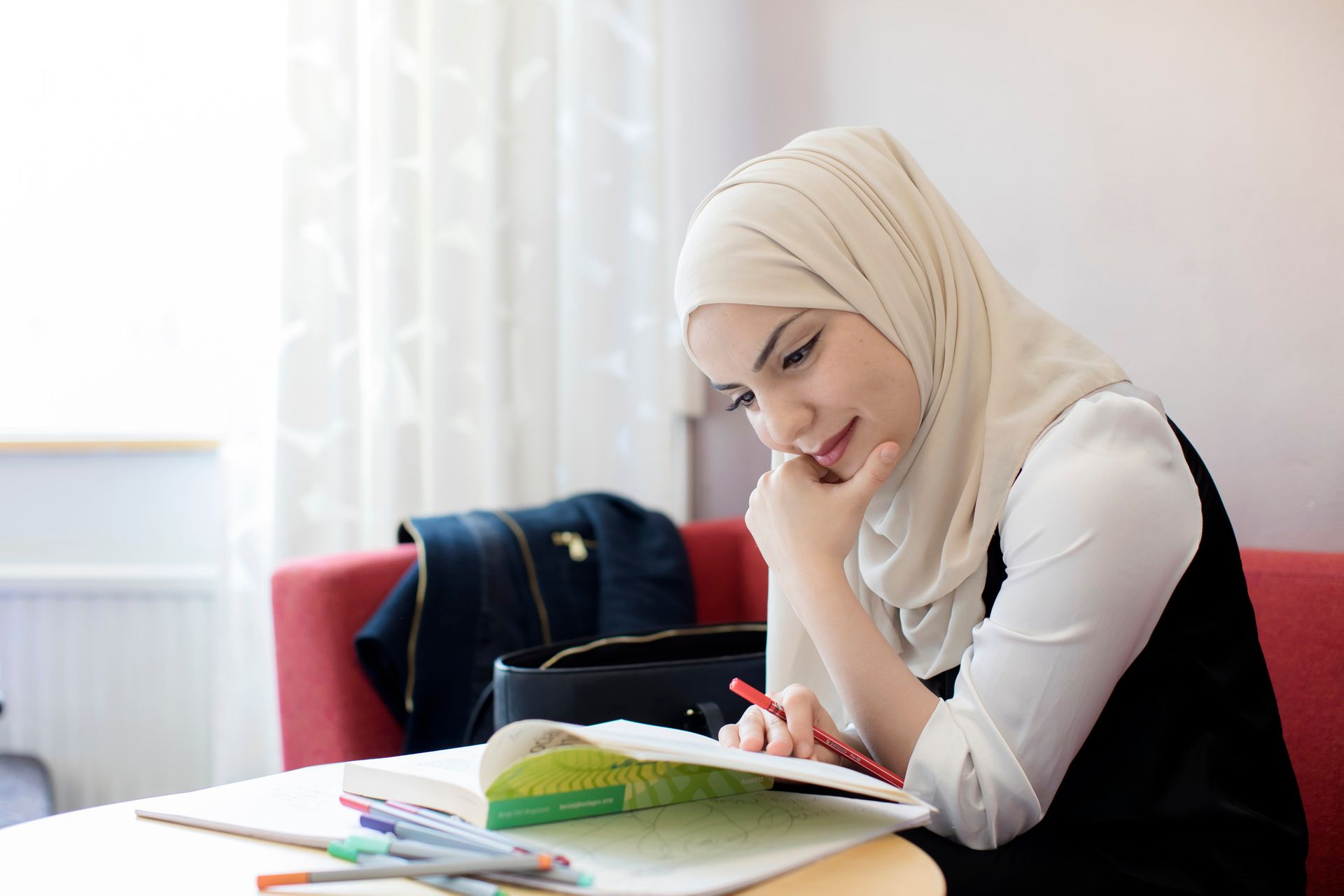 A girl sitting and reading a book