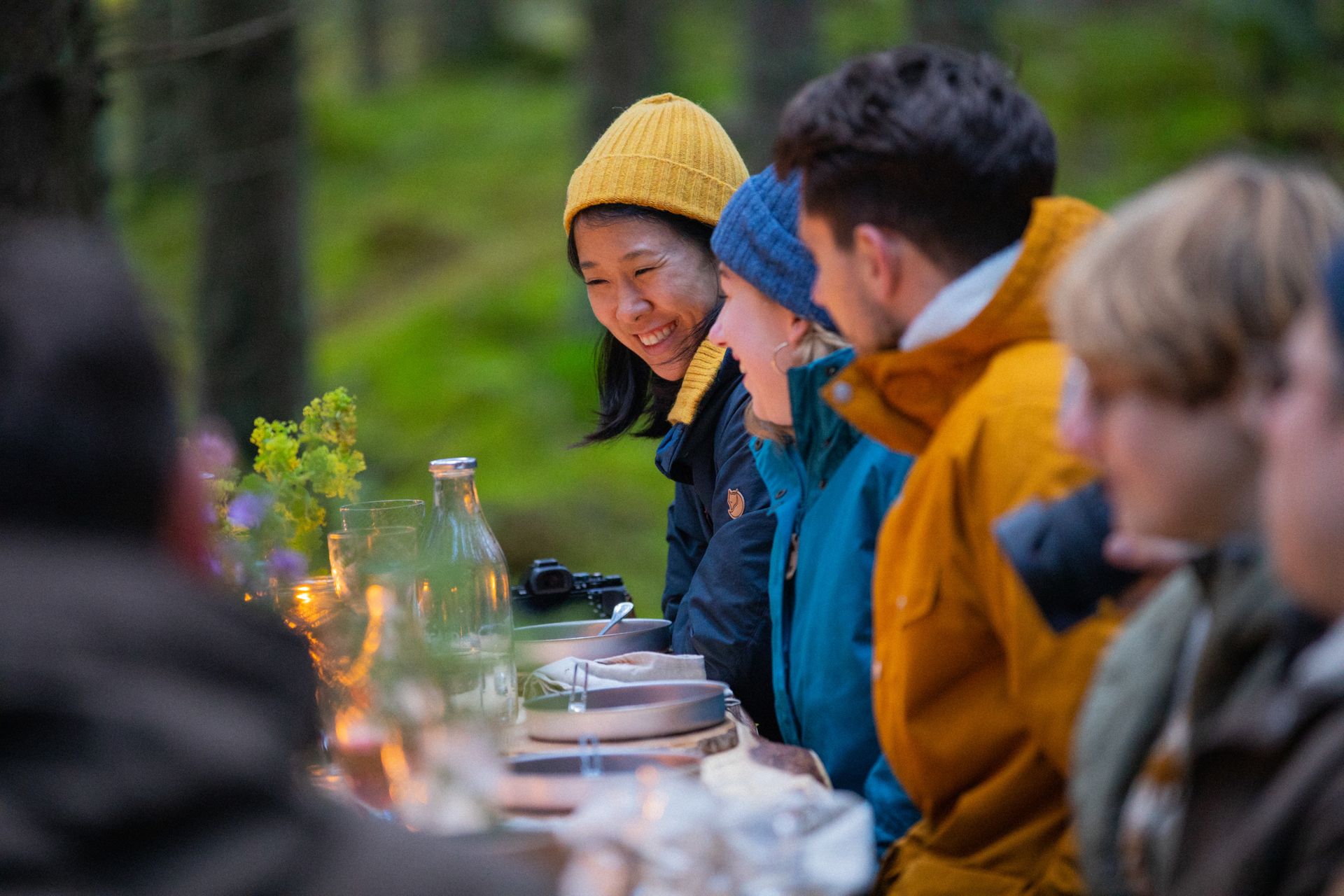 Photo showing international people around a table eating and laughing