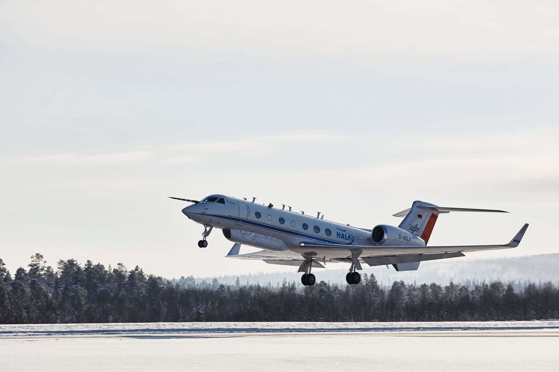 A small passenger airplane taking off from a runway in the north of Sweden.