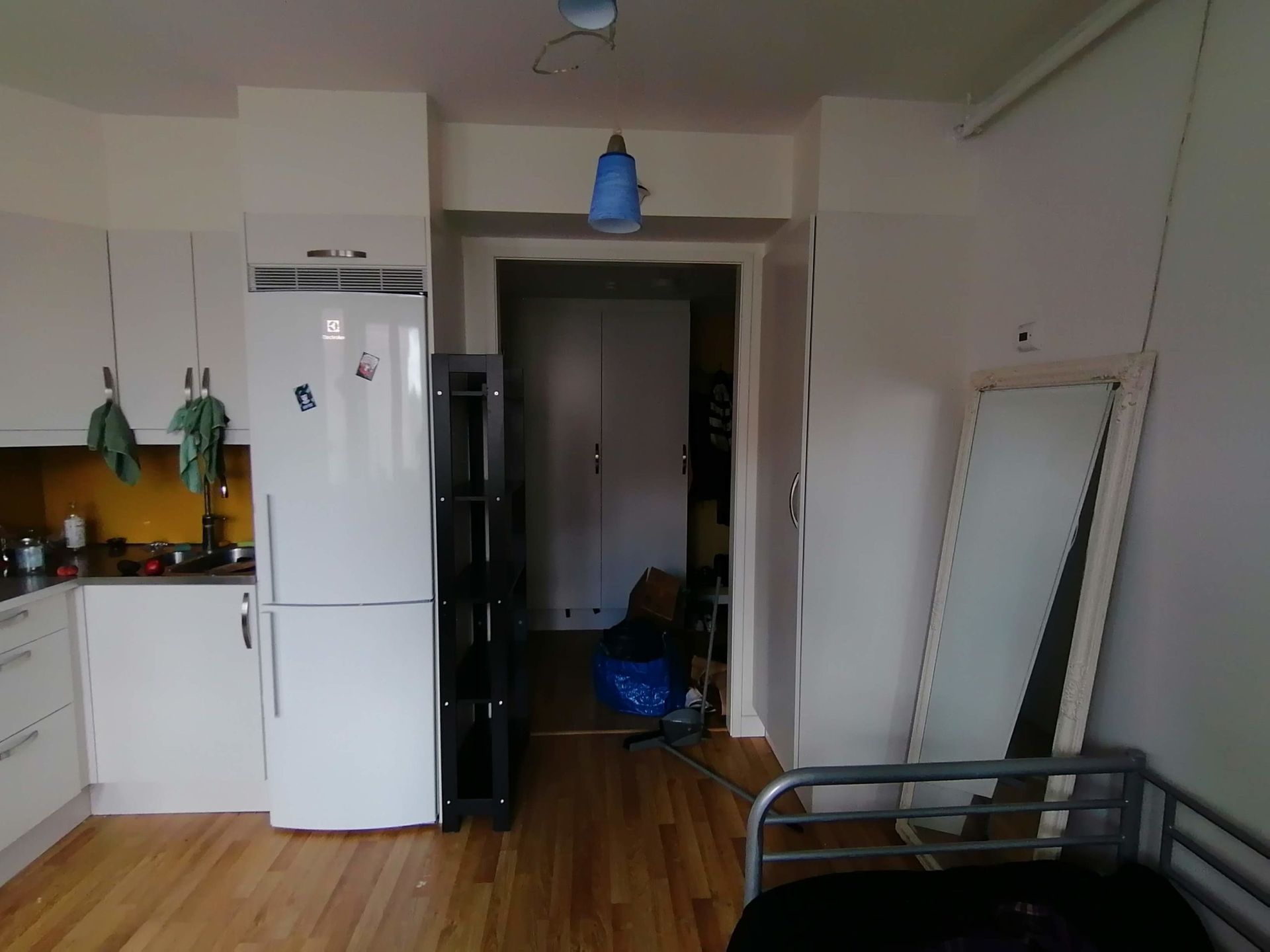 A door frame next to a fridge in an apartment