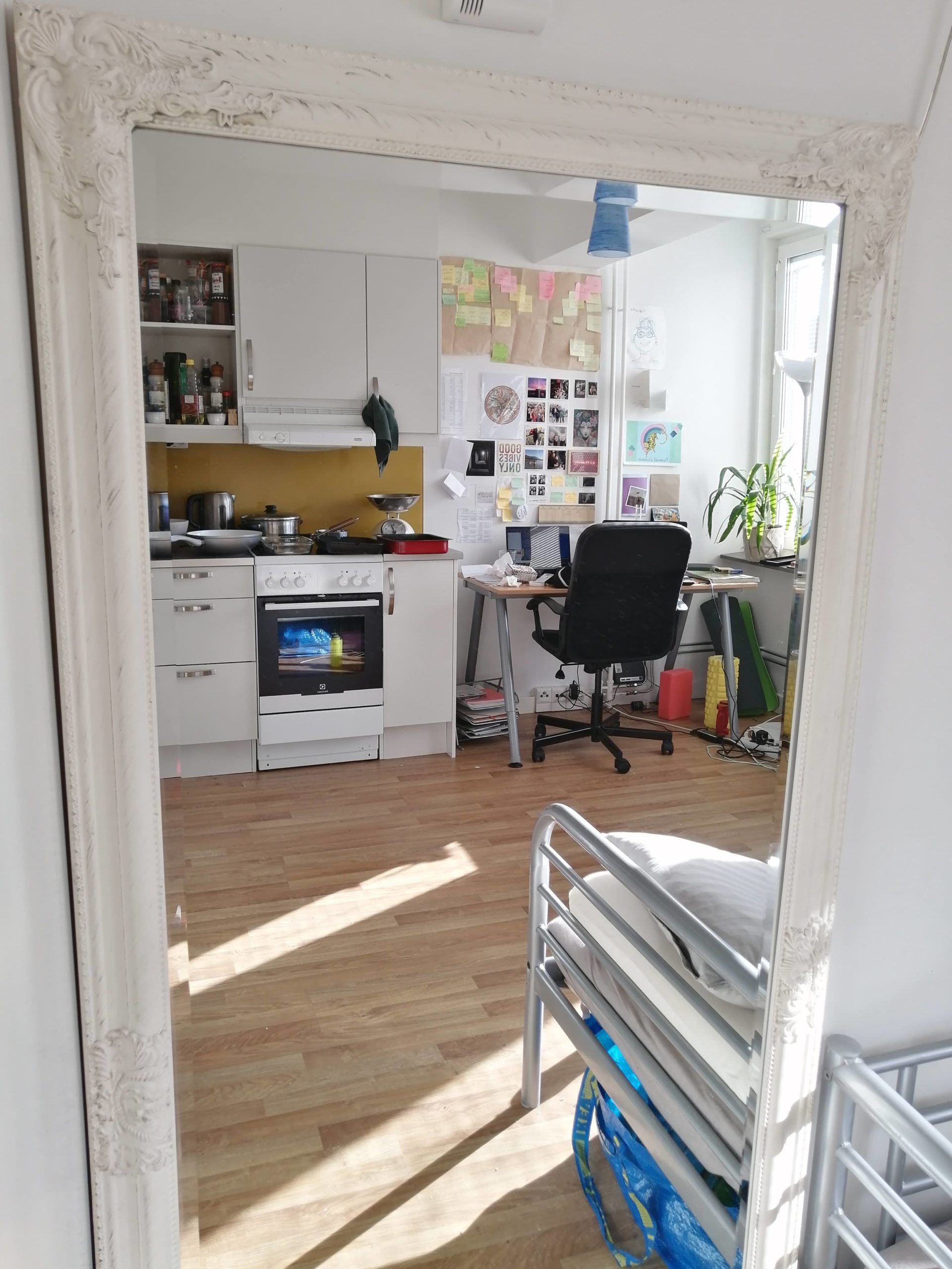 A mirror reflecting a room in an apartment