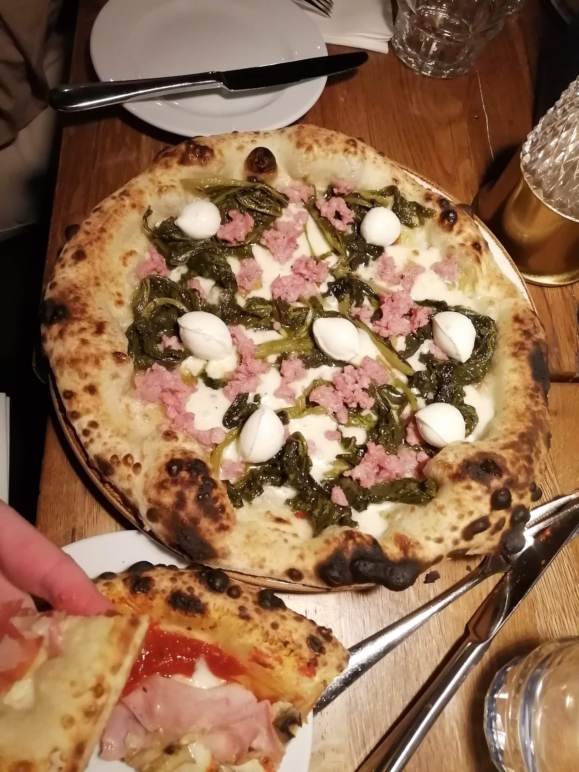 A ham, burrata and wilted spinach pizza