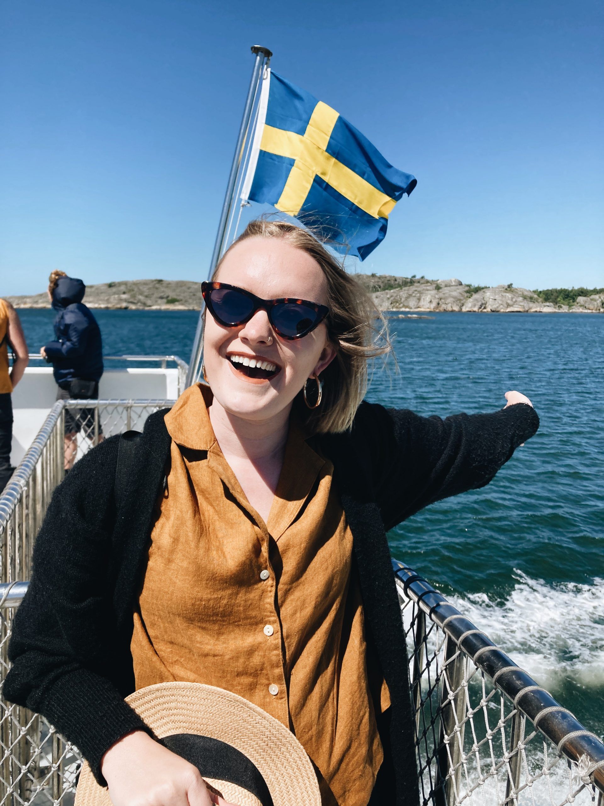 girl on boat with arms up