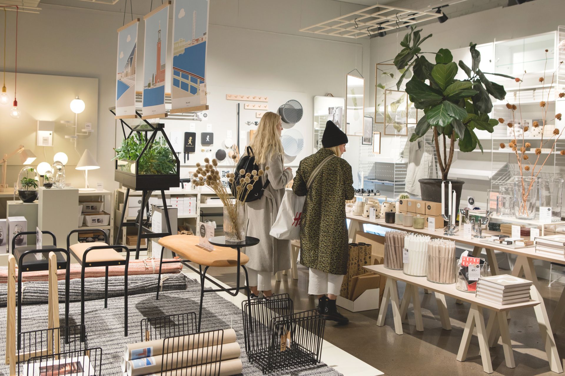 Two women are shopping in an interior design shop with a lot of Scandinavian design items.