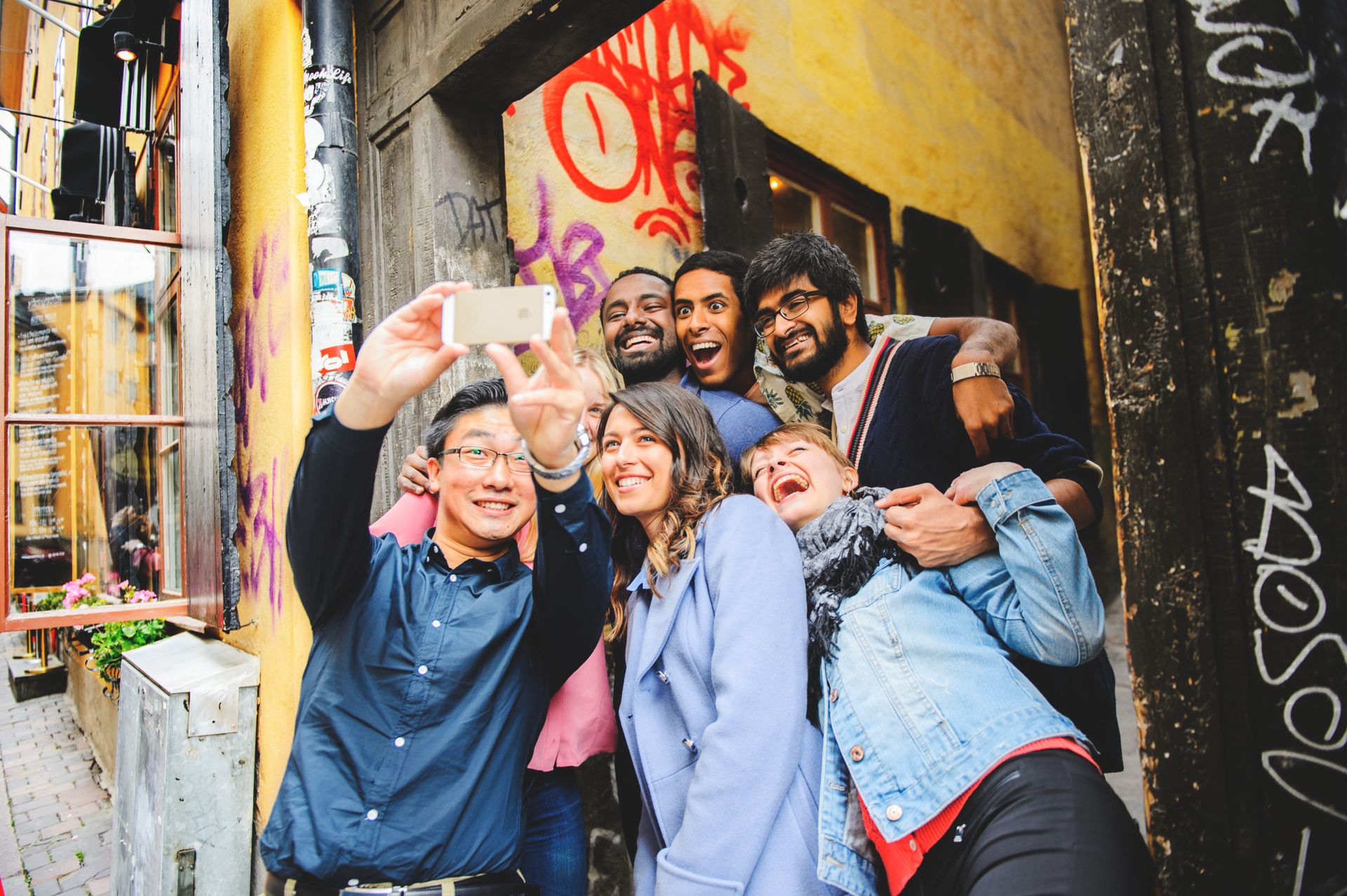 People of different nationalities taking a selfie together.