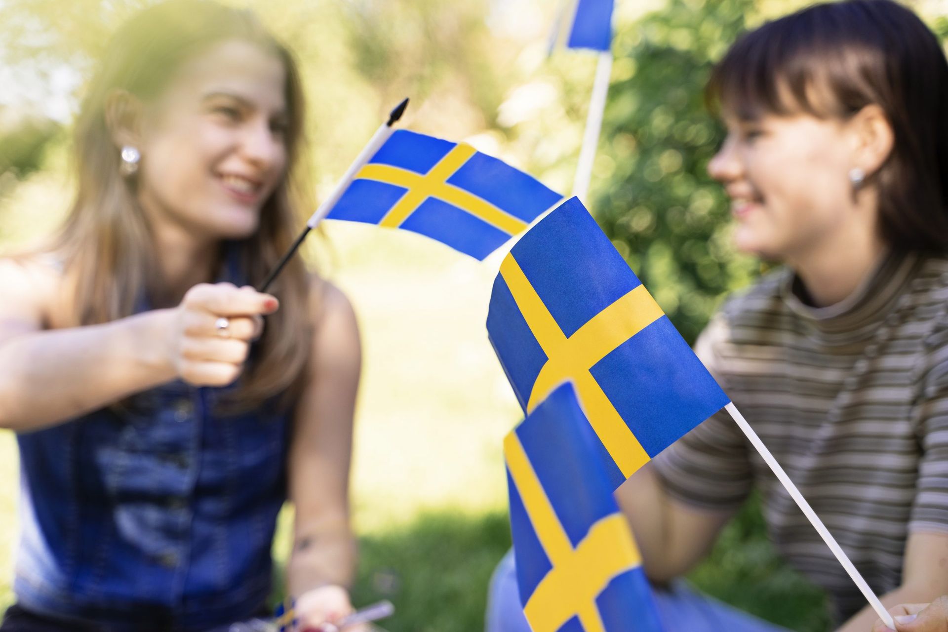 Grls celebrating with Sweden flags