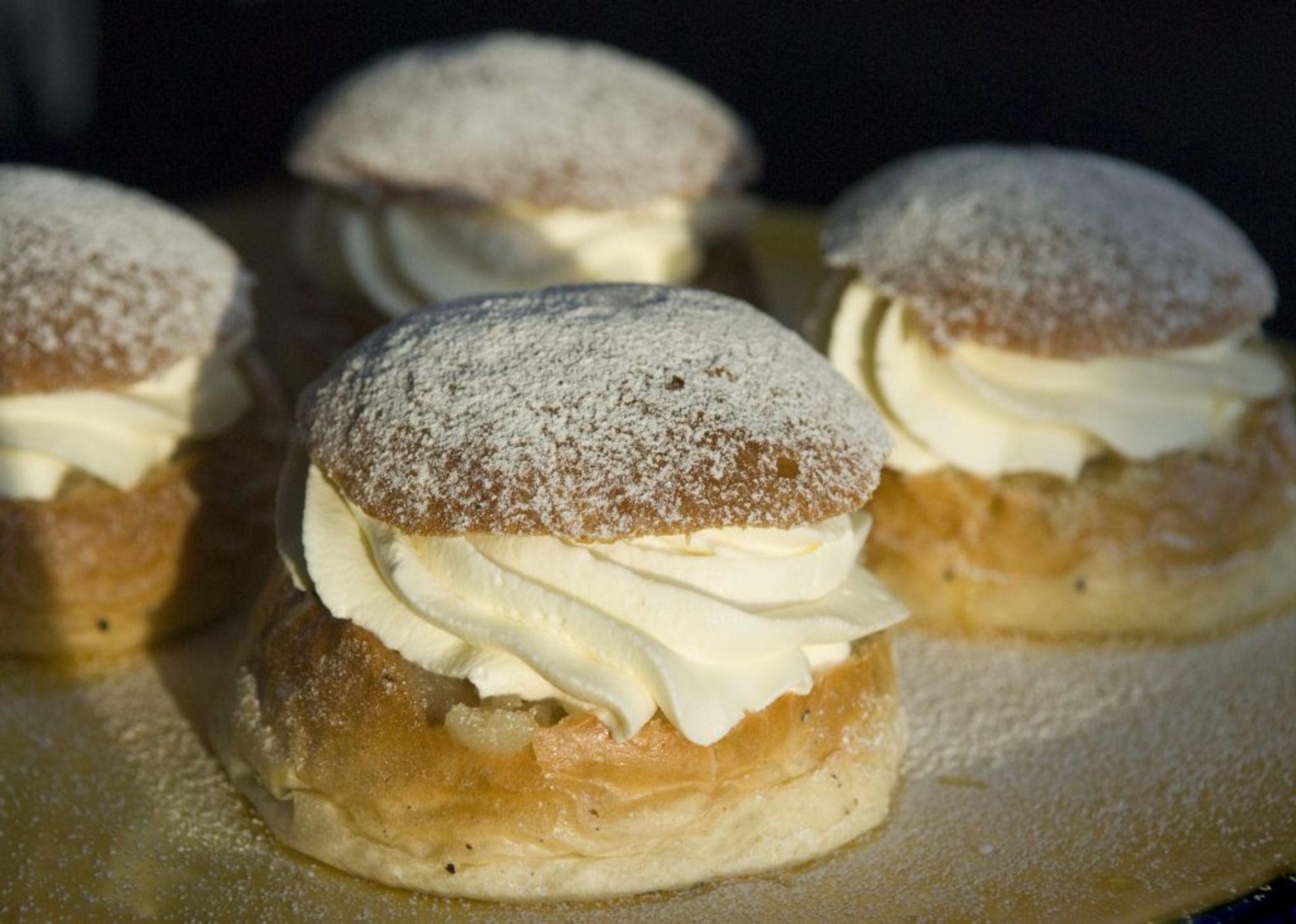 A close up of a cardamon bun (called Semlor in Swedish). A bun with almond paste and whipped cream.