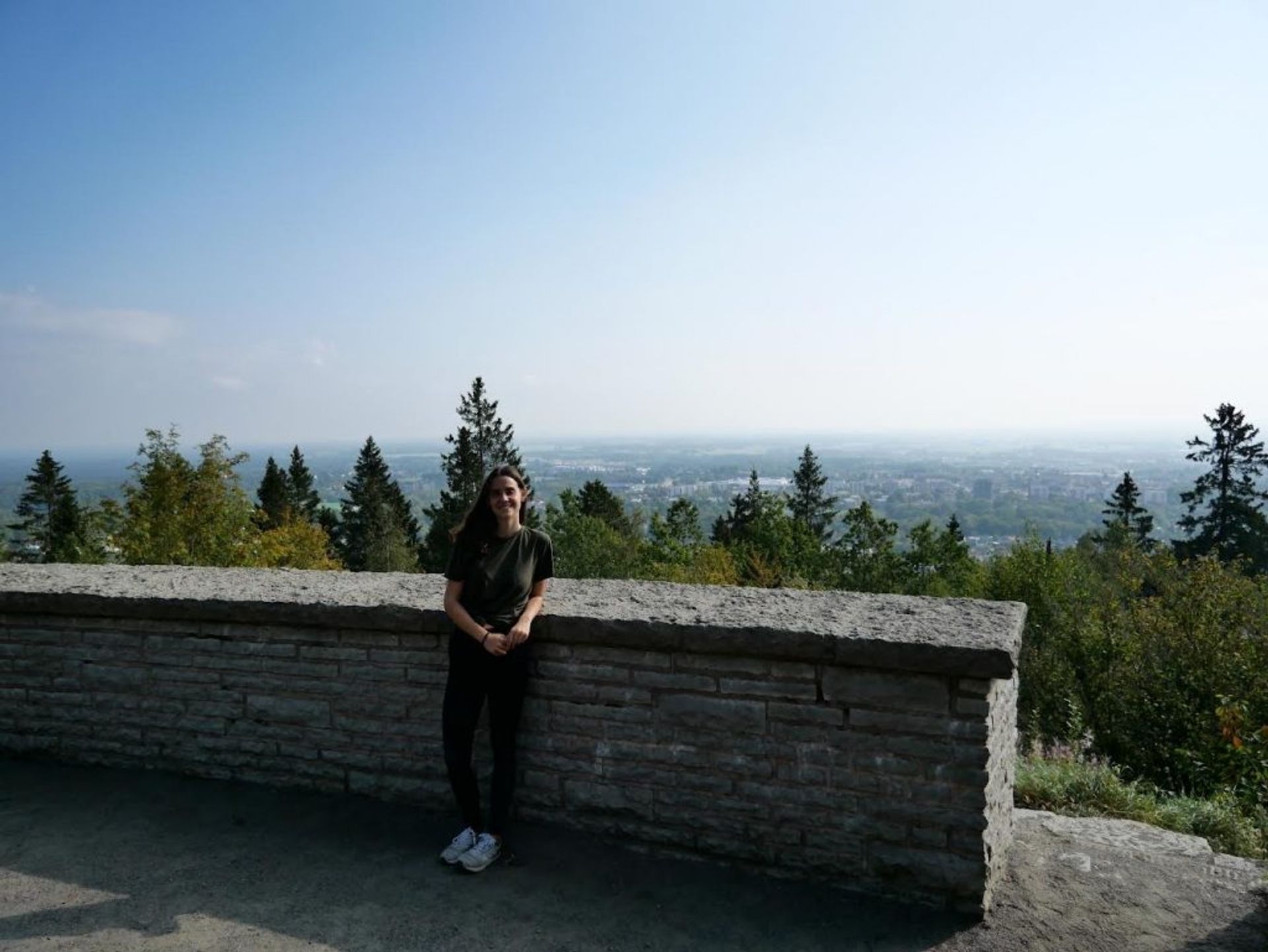 A girl with a great view of the city in the background. 