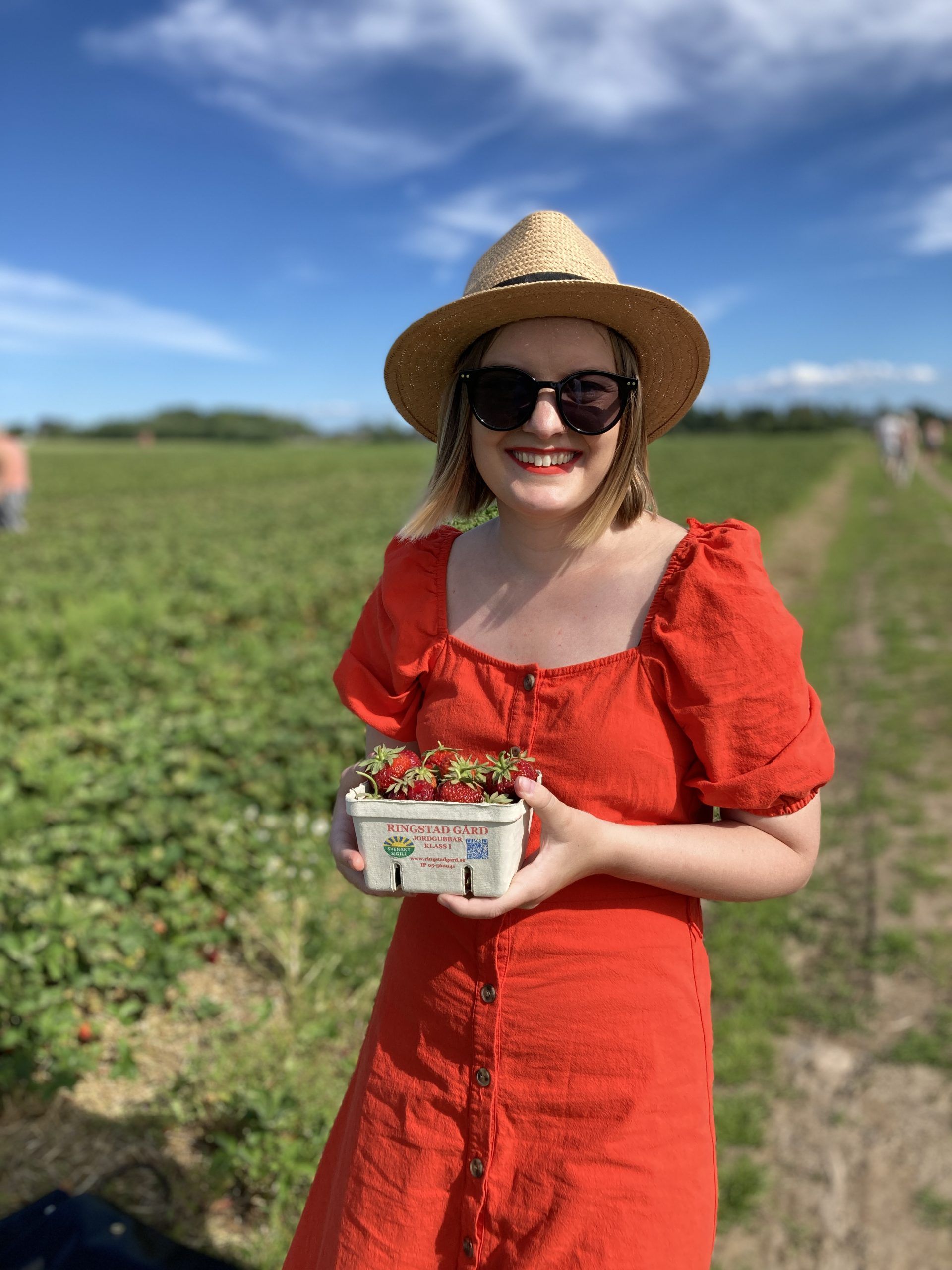 girl holding basket of strawberries