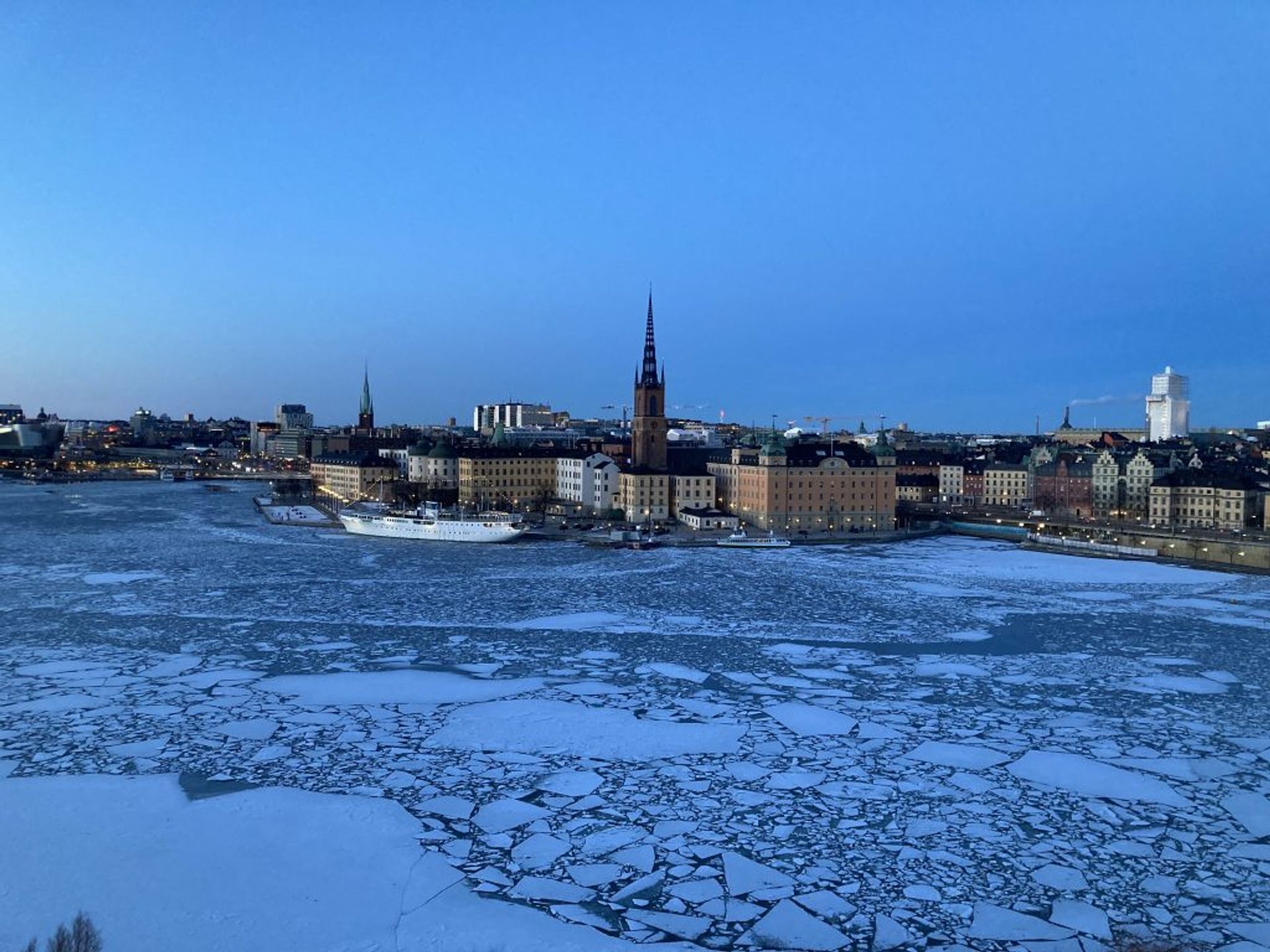 A view of the frozen river and the buildings in Stockholm in the evening,