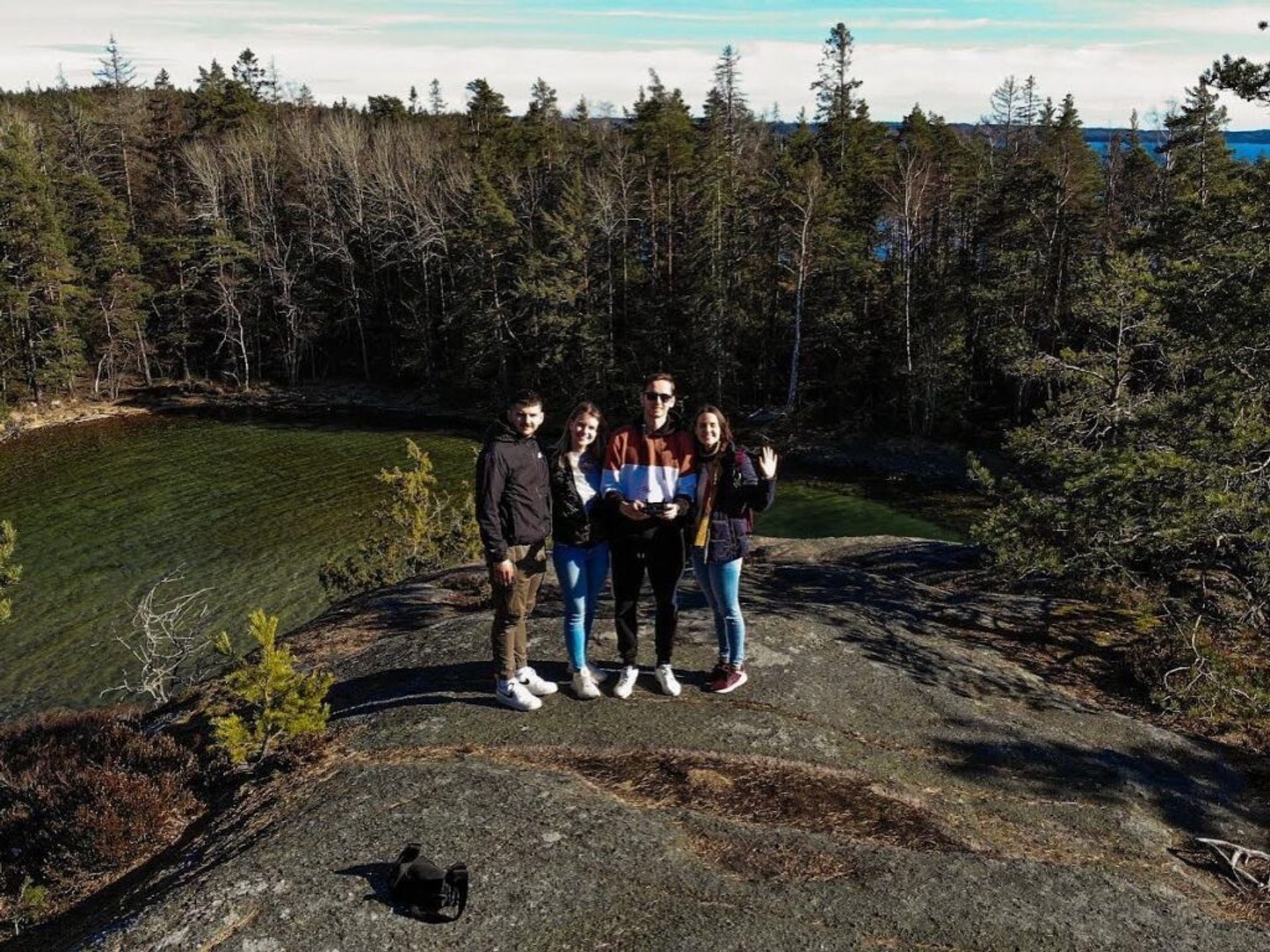 Group of people posing for a photo in a forest.