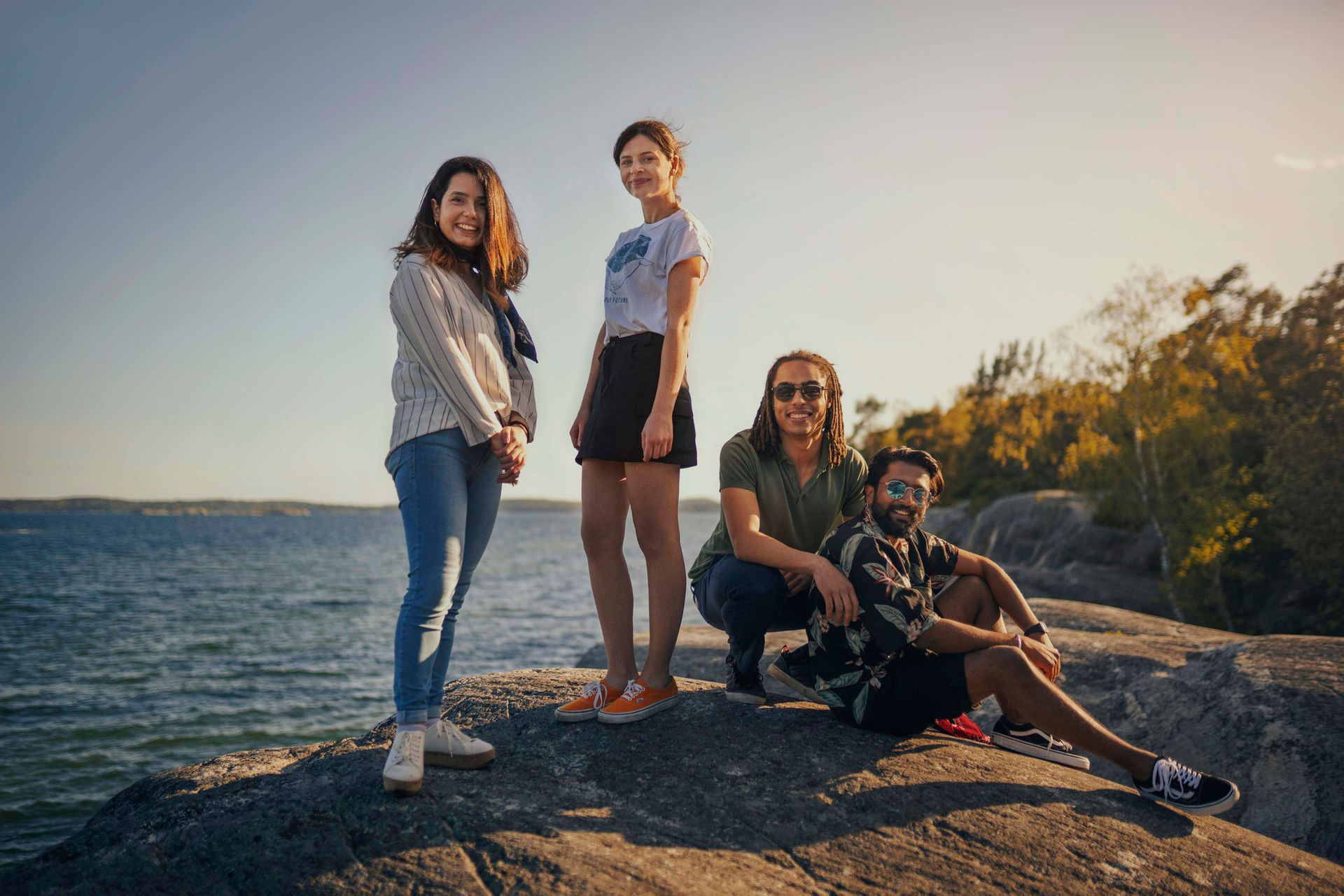 Four students standing in front of the sea.