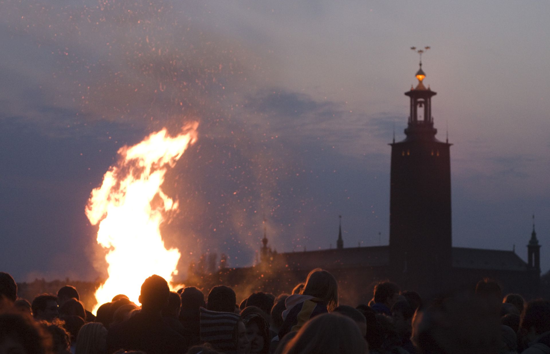 photo of bonfire and stockholm city hall