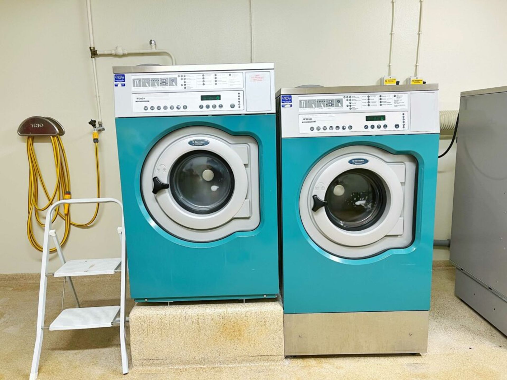 Two blue washing machines. 
