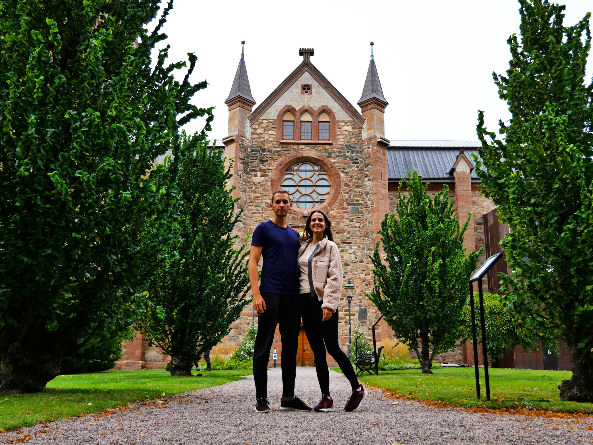 A couple with an old church in the background.