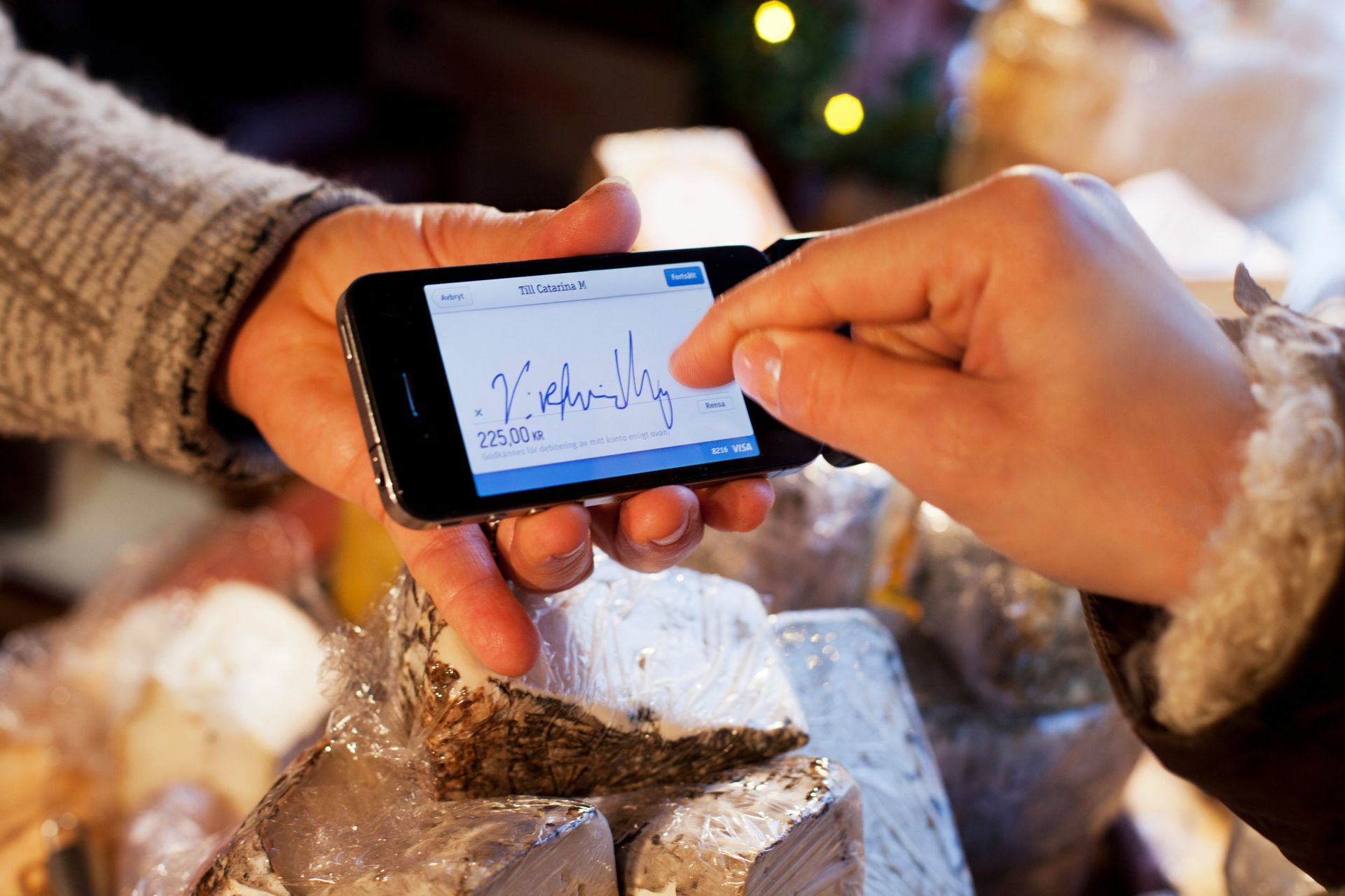 A phone showing someone's signature on the screen.