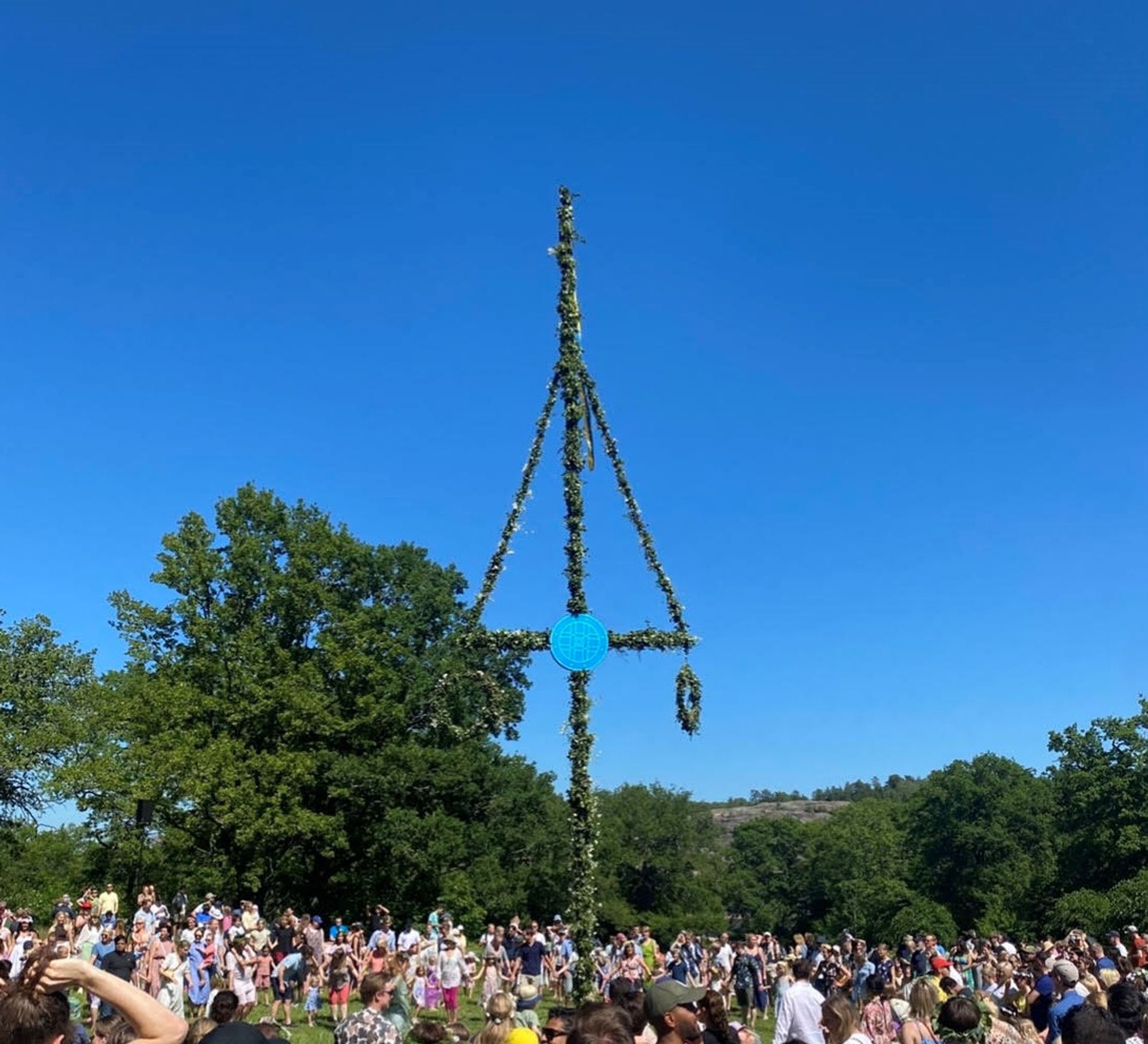 A lively Midsummer celebration in Nacka district, with people dancing around a Midsummer pole.