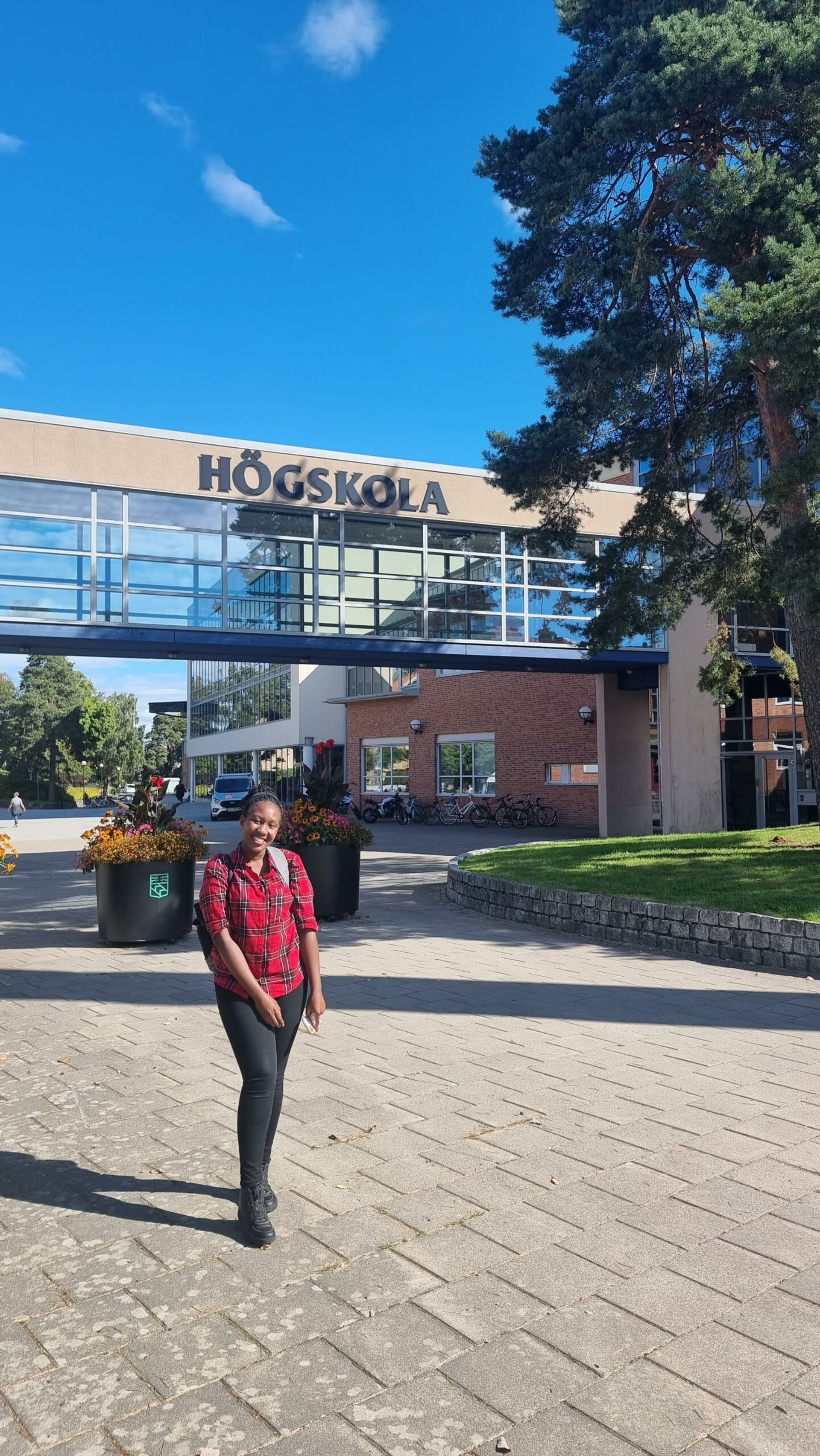 Digital Ambassador Nozinhle posing in front of a University West campus building.