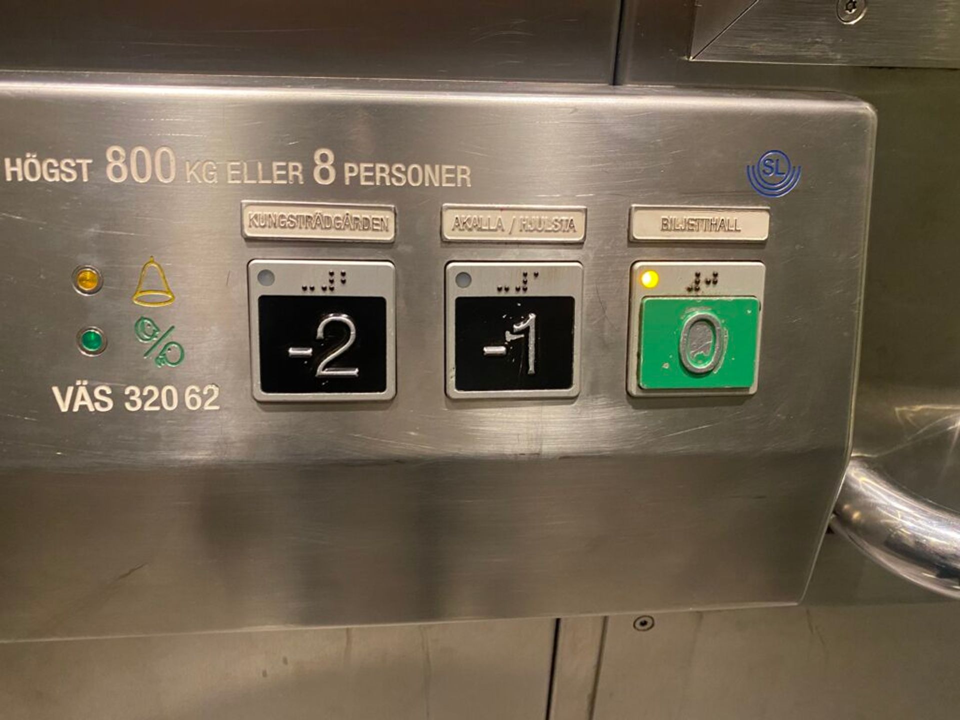 Elevator panel displaying buttons for various floors at a metro station.