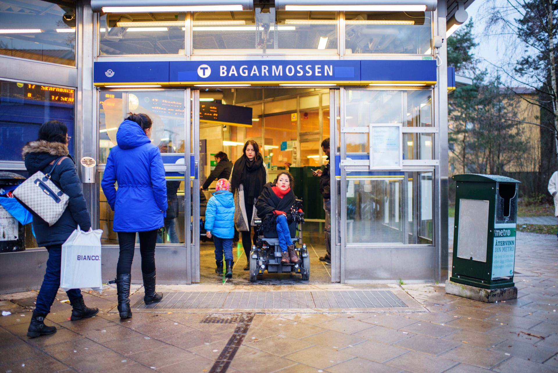 People entering and exiting a Stockholm metro station.