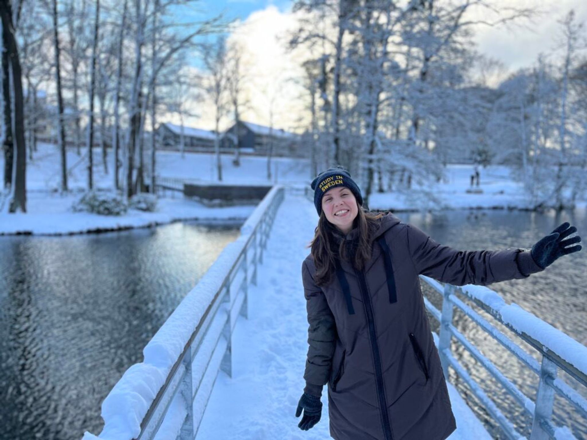 A girl smiling with snow in the background