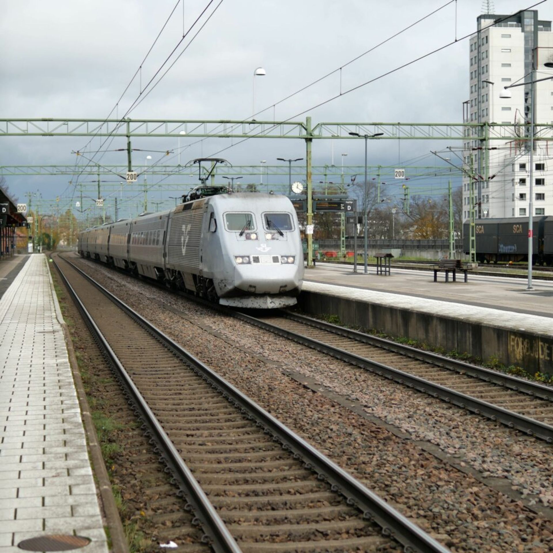 An SJ train approaching a station.