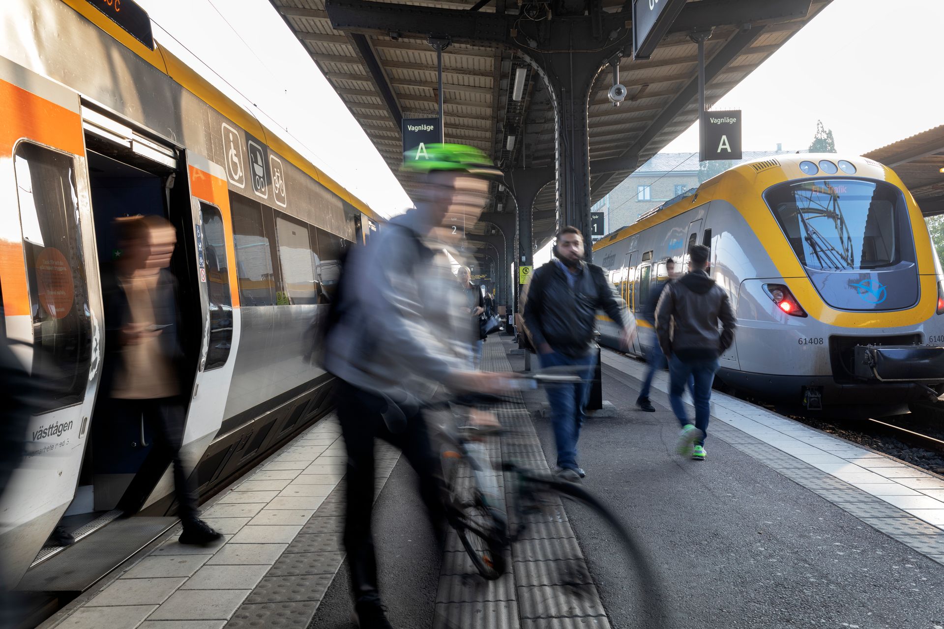 A man on a train platform with a bike.