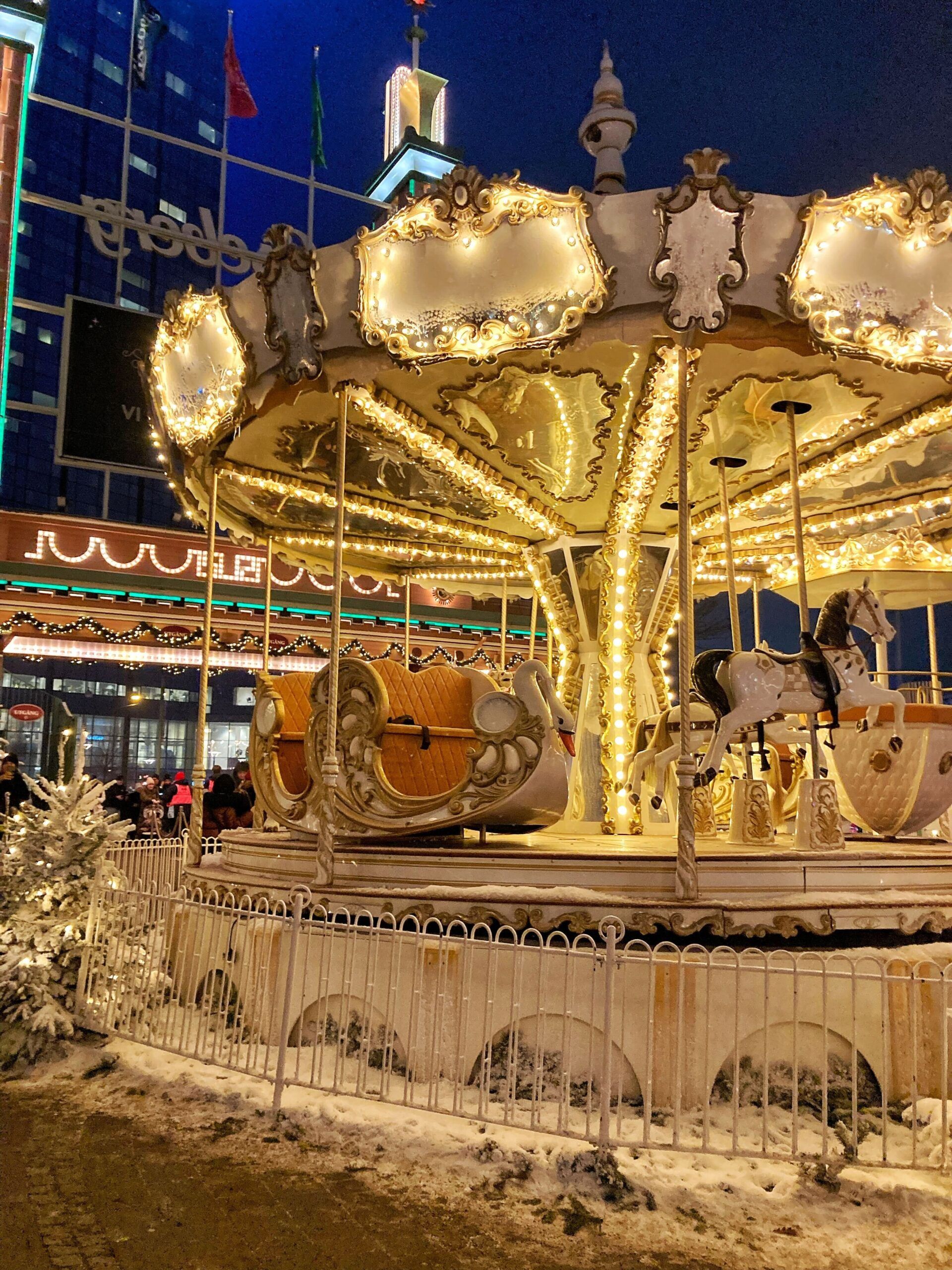 A carousel aglow with colorful lights, casting a warm ambiance.