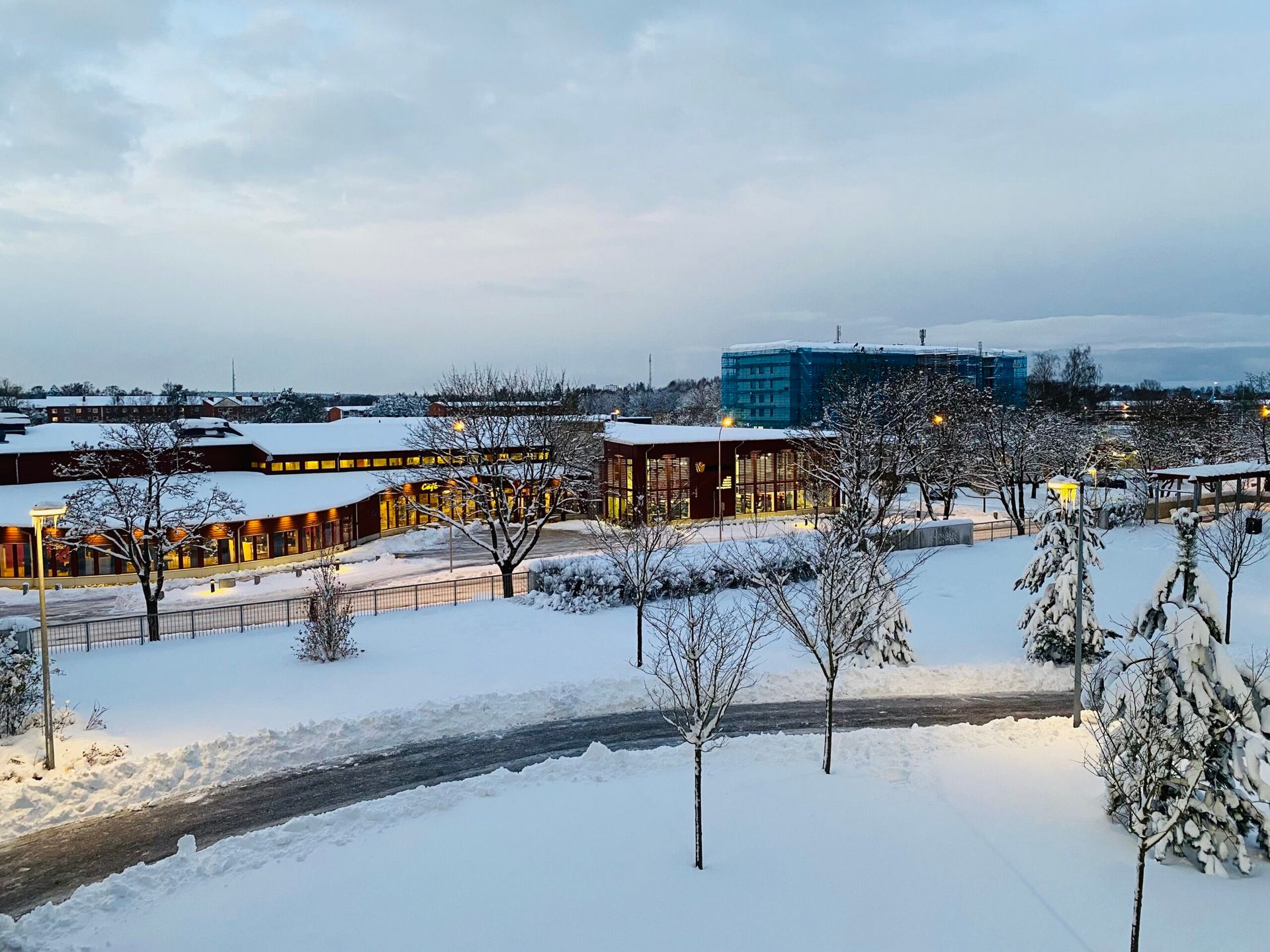 A view from an apartment window of an urban setting during winter.