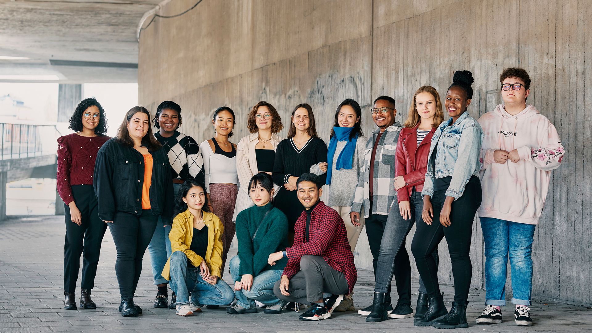 A group photo of 14 international students.