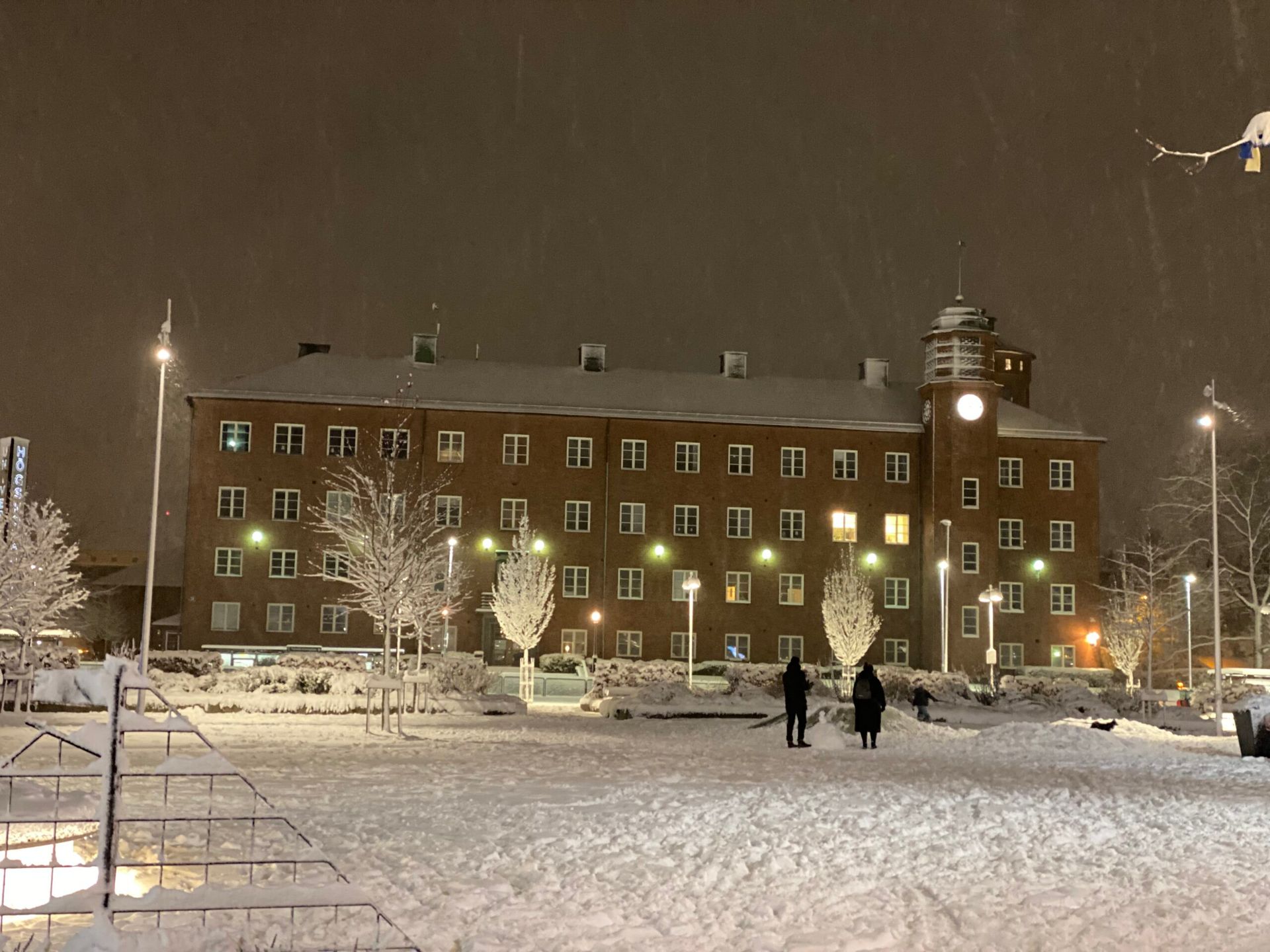 A winter night view of a campus building at University West.