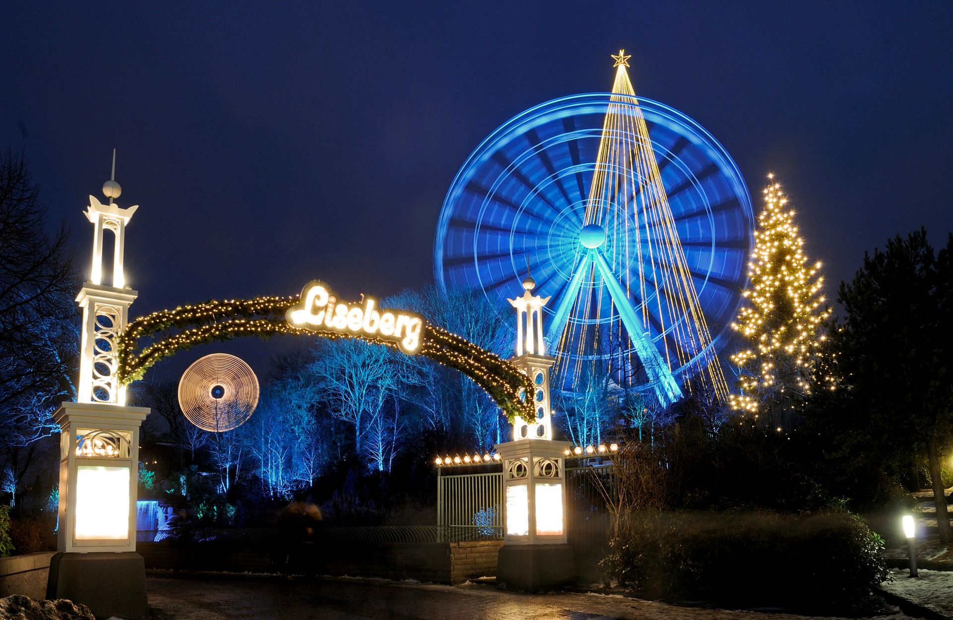 The Liseberg park entrance with a ferris wheel and Christmas lights in the background.