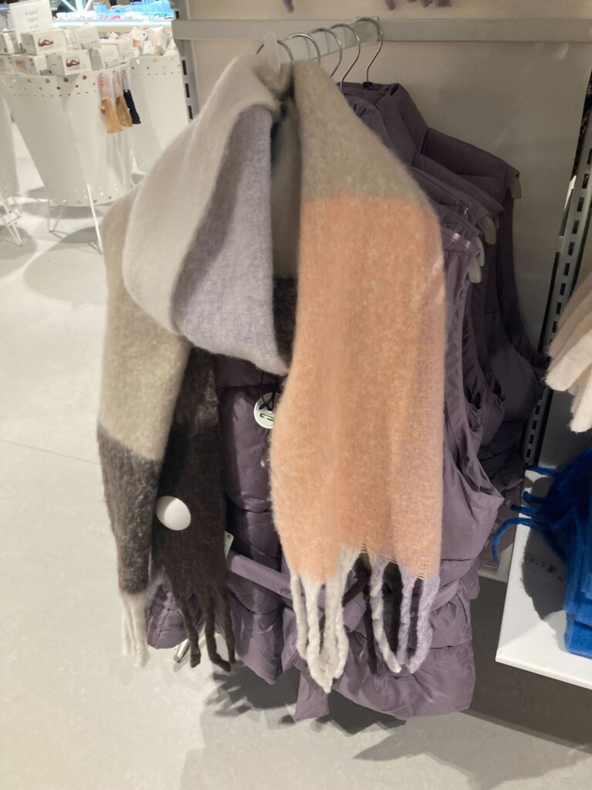 Winter accessories on display in a clothing store.