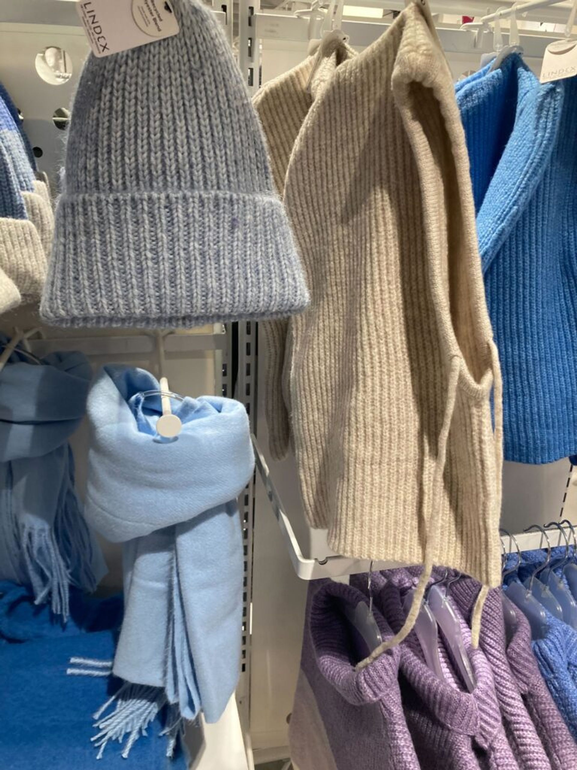 Winter accessories on display in a clothing store.