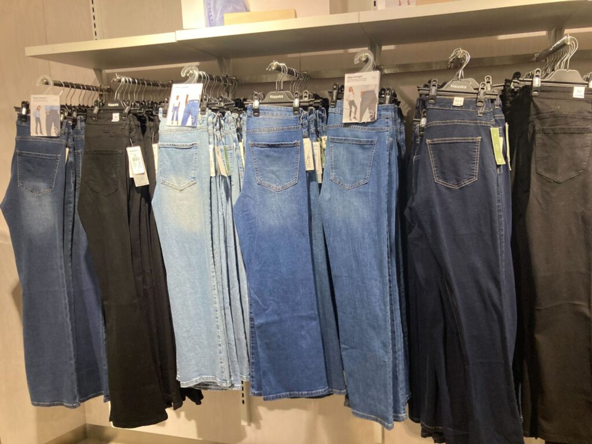 A variety of jeans on display in a clothing store.