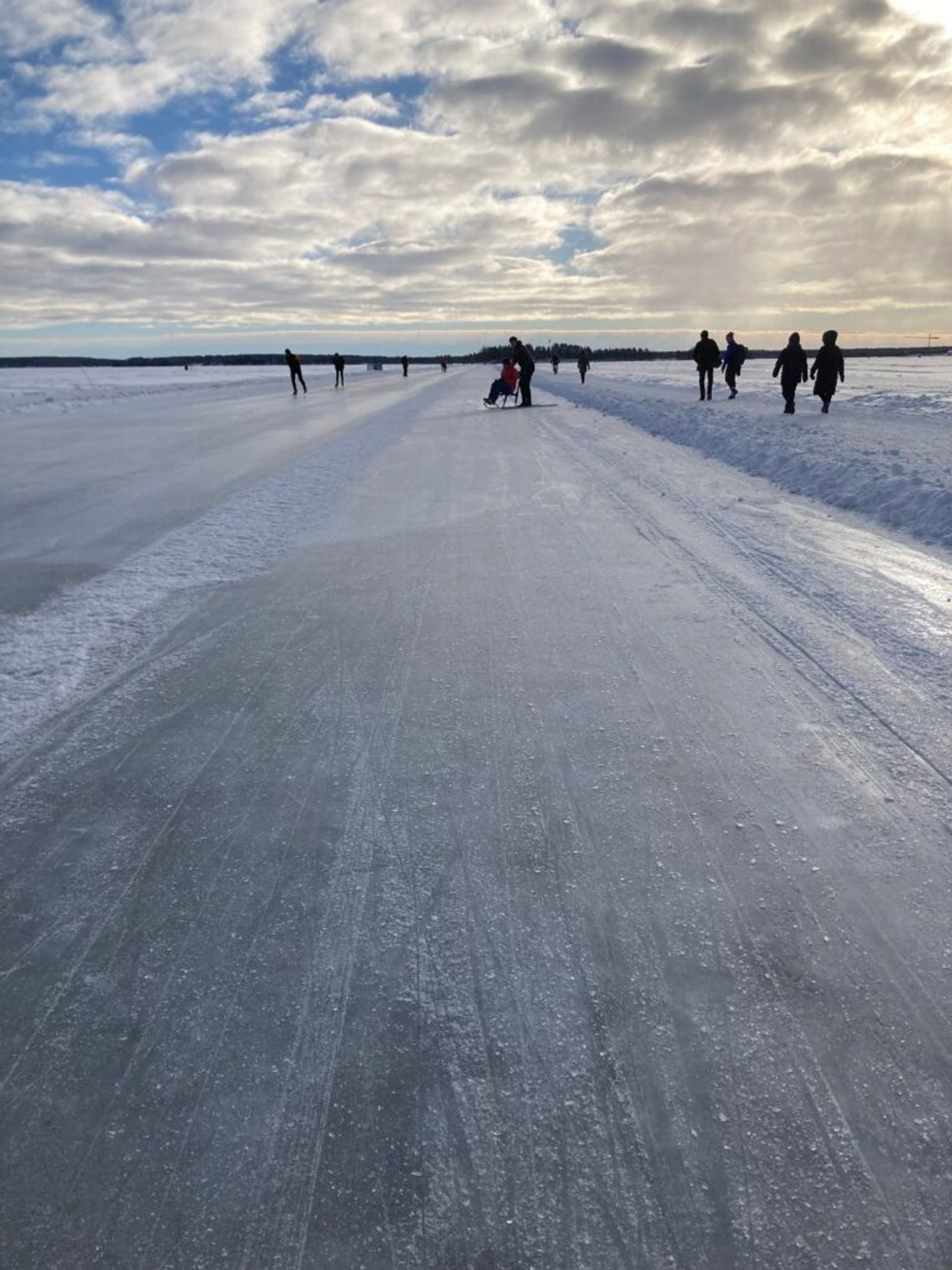 An ice track in Luleå with people in the distance.