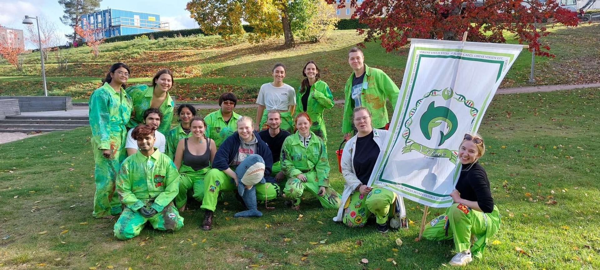 students in green overalls