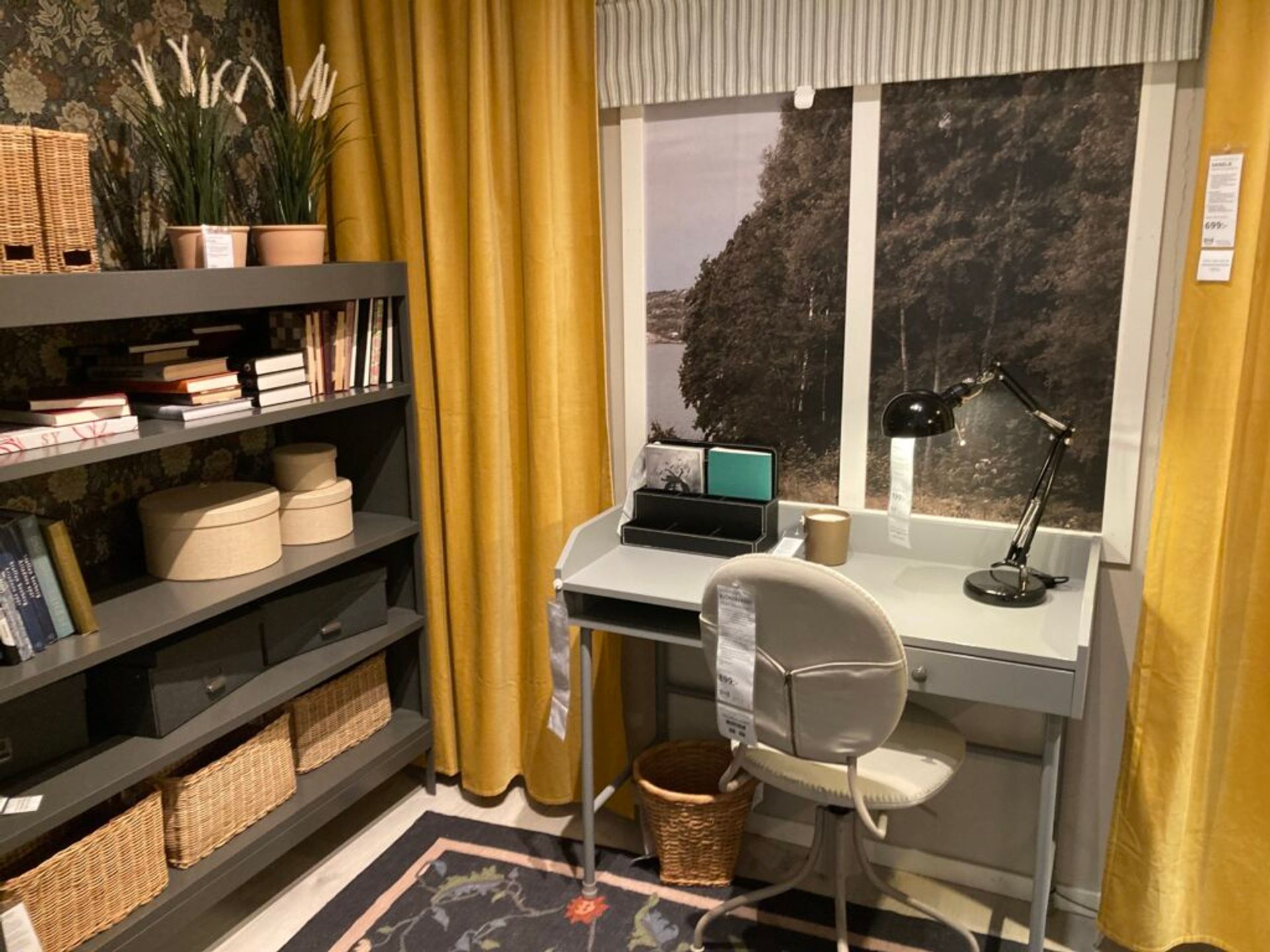 A showroom at IKEA featuring shelves and a desk area.