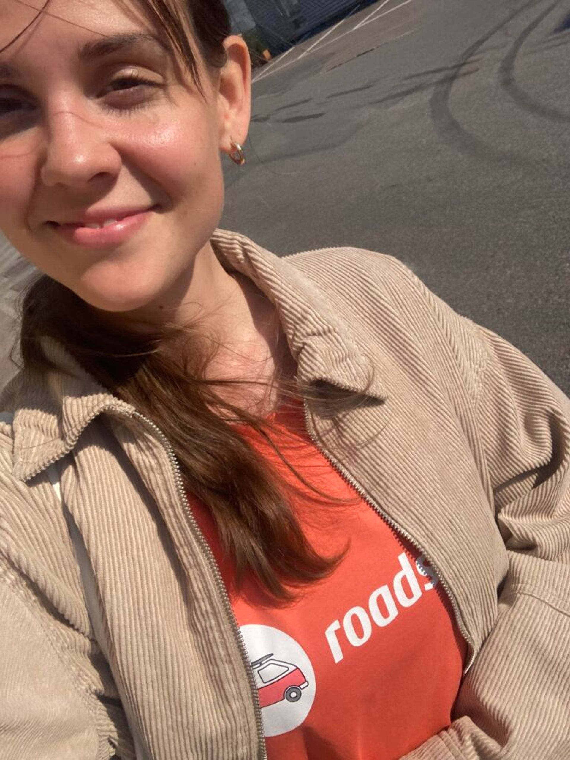 A cheerful selfie of a woman on her way to work.