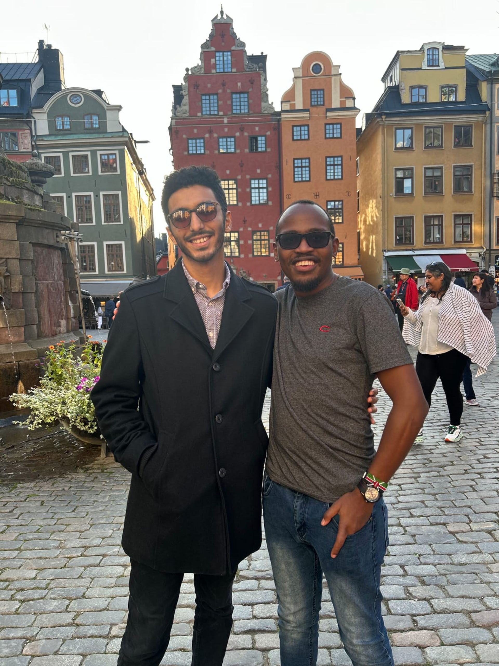 Two people beaming with joy in Gamla Stan, Stockholm's historic old town.