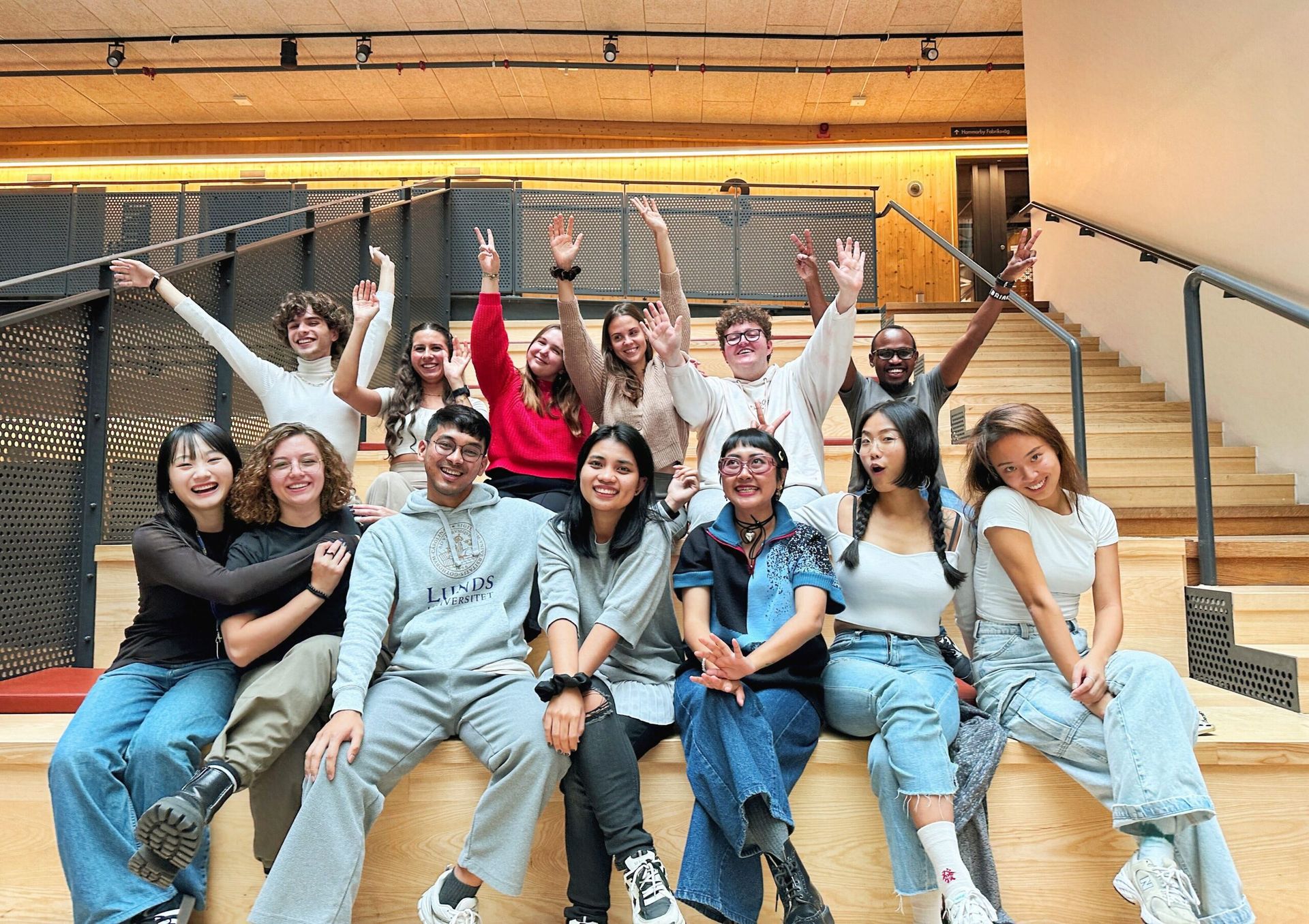 Digital ambassadors representing SI, smiling together on a staircase.